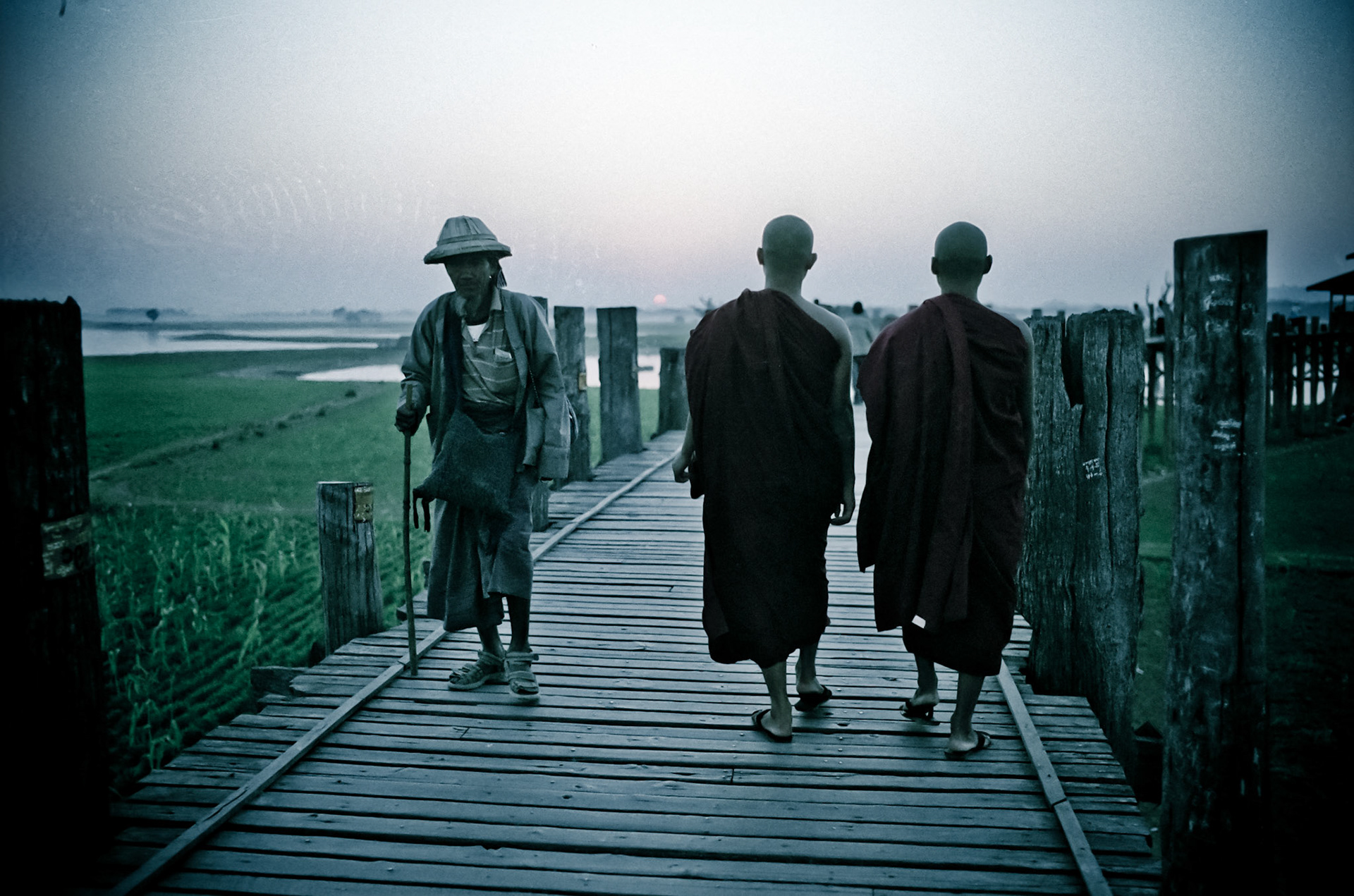 Early evening in Amarapura sees hundreds of monks cross teh U Bein bridge back to their monasteries. Meaning "City of Immortality" Amarapura, a former capital of Burma, is famous for the U Bein bridge that crosses the a small lake and is the world's longest teak bridge