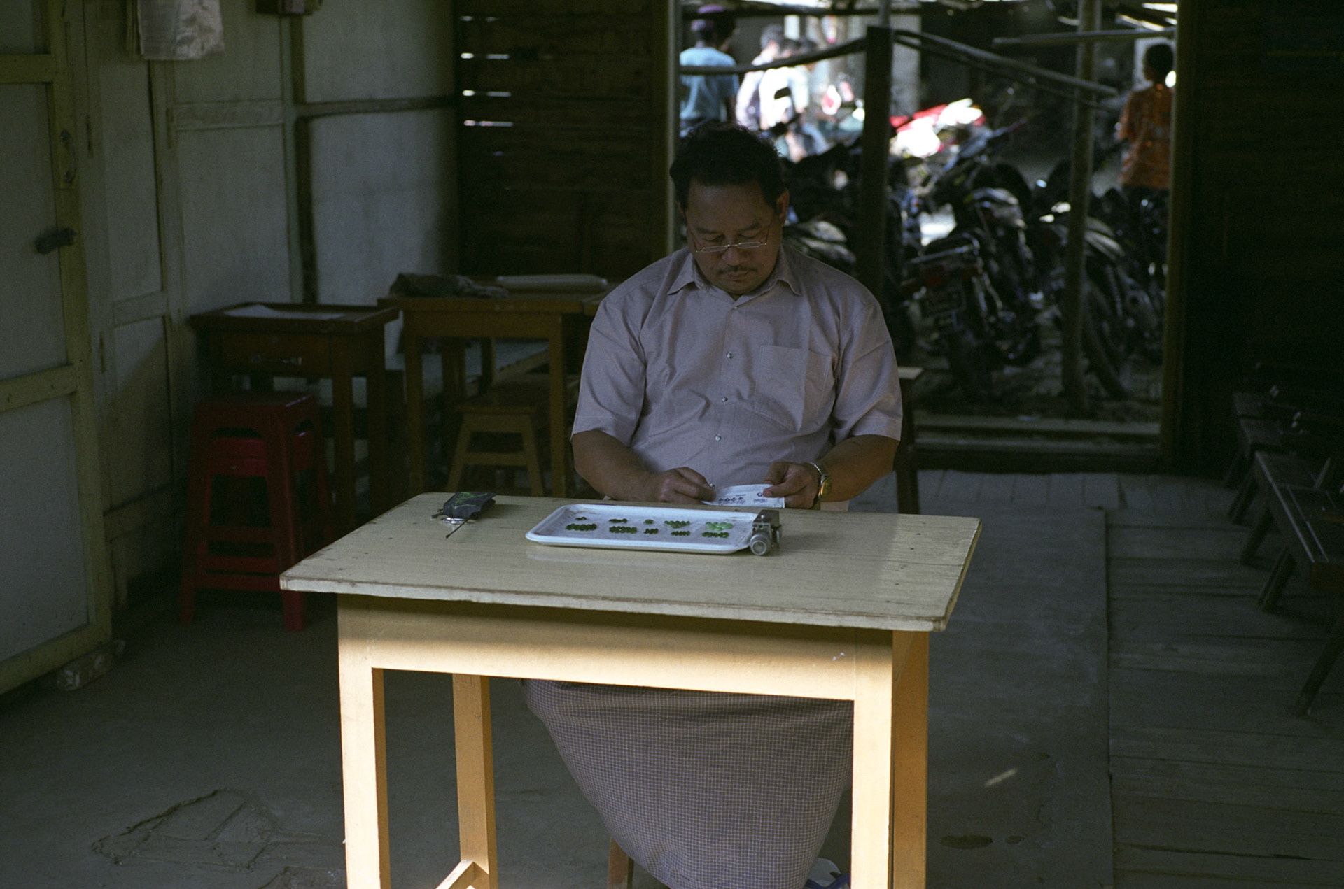 Traders prepare and deal in Burmese jade at the Mandalay jade market. Burmese jade is the most precious and the finest quality in the world. Whilst Western sanctions prohibit trade and import, it is a lucrative business for Asian countries, in particular Chinese dealers and brings in millionsn of dollars in revennue to the military regime