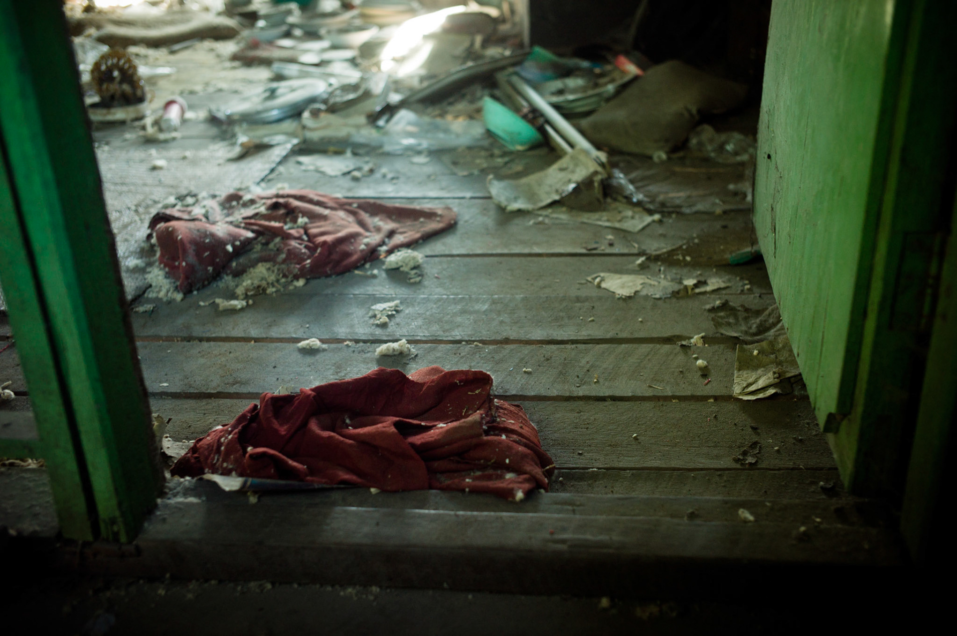 Robes torn from the bodies of monks as they were arrested in the dark of night on 26th September 2007 still lie on the floor in the doorway. On September 26th 2007, at the height of Burma's monk led Saffron Revolution, Maggin Monastery in Rangoon, was raided as the regime commenced its brutal crackdown on the protests. On 13th January 2012 the monks were released from prison and more than four years since the monastery was raided and locked, they returned and opened the doors once more. Everything they found was exactly as it was left the night the military regime arrested them and ransacked the buildings.