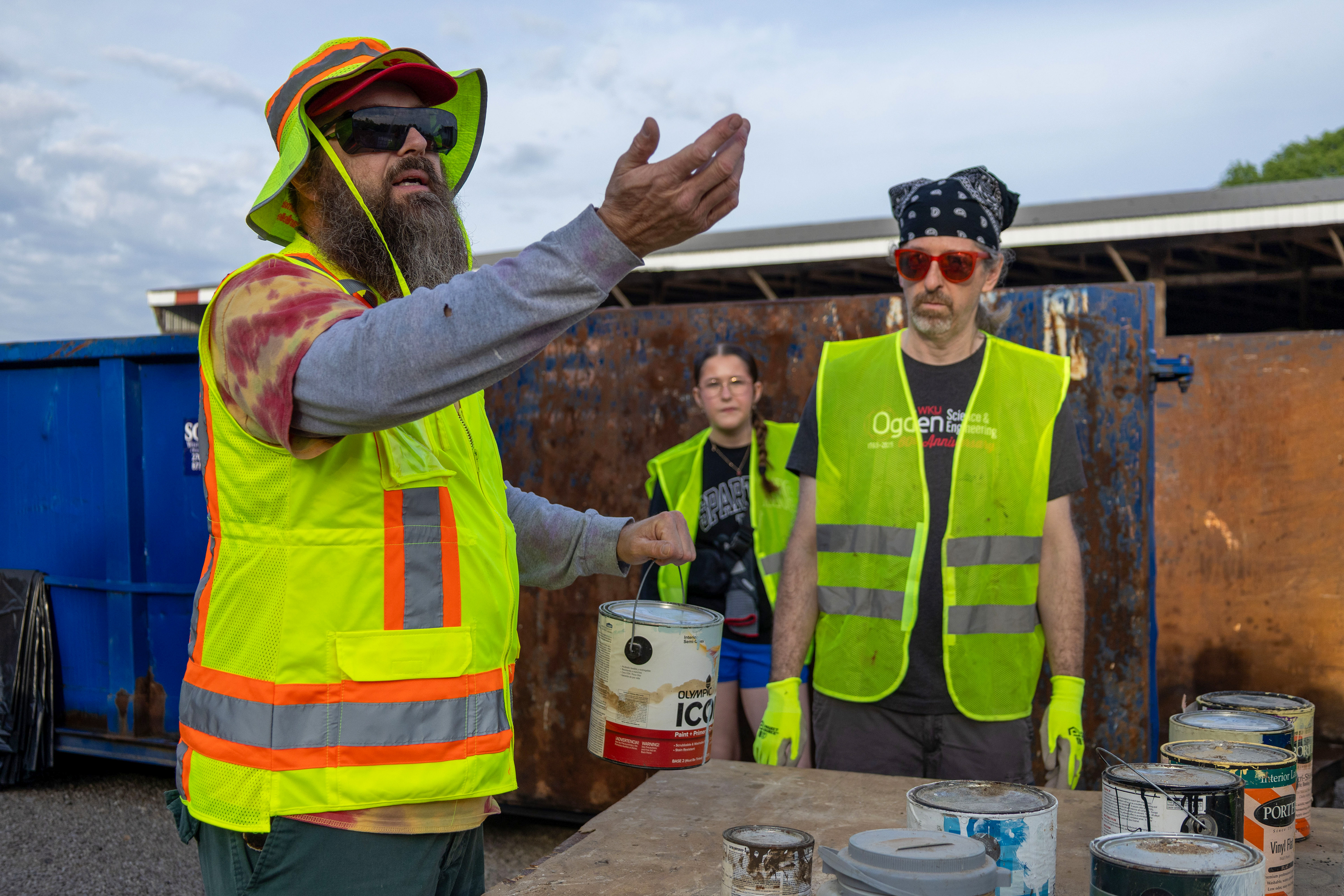Bryan Reaka (left), an associate professor in the School of Engineering and Applied Sciences and the advisor for WKU Habitat for Humanity, shows volunteers how to determine if paints are oil based or water based at Household Hazardous Waste Day on Saturday, April 25. Oil based paints and water based paints needed to be disposed of in different ways. 