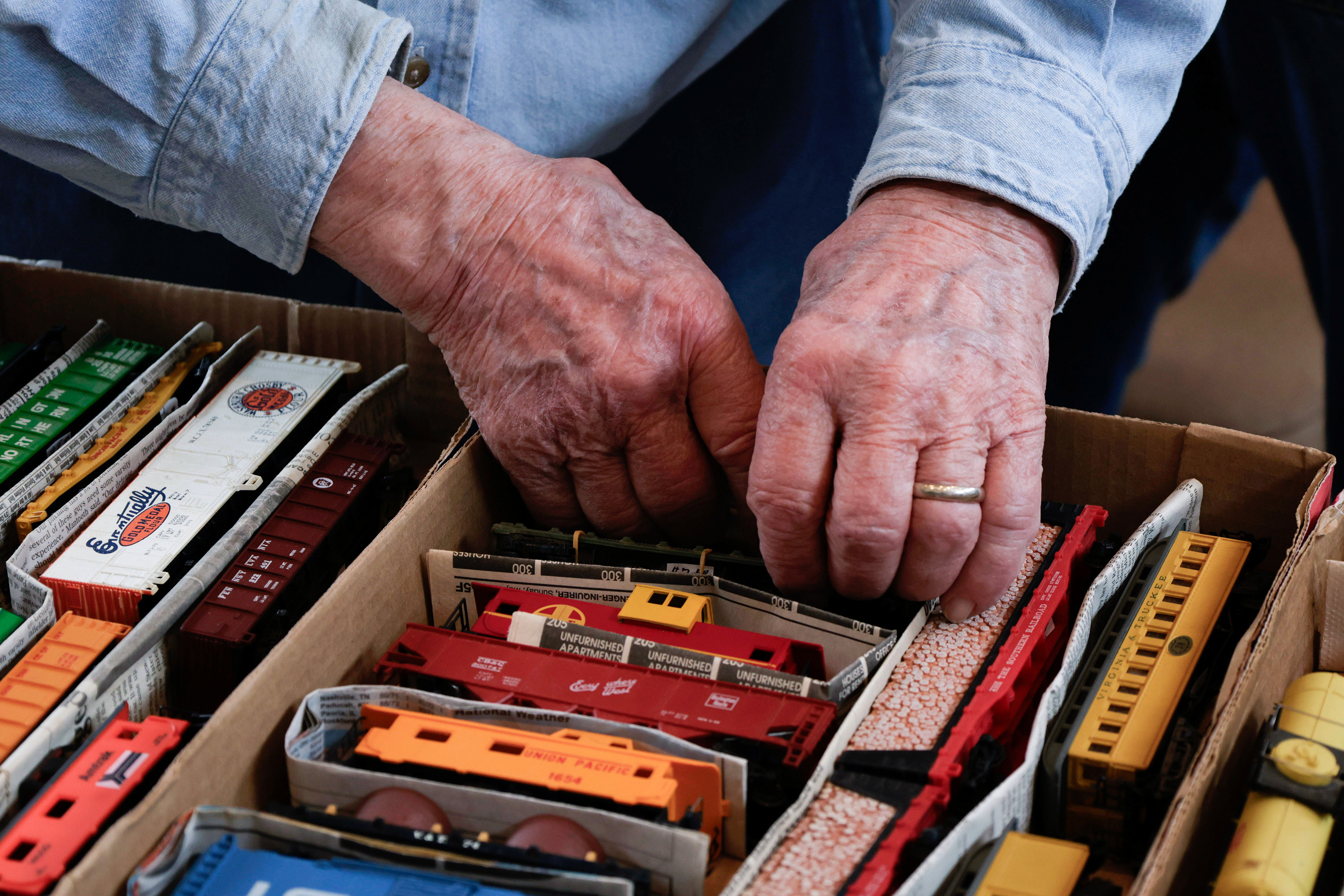 Ed James, 89, rummages through his model trains at the Model Train Show and Sale at the Historic RailPark and Museum on Feb. 22, 2025. He is the oldest member of the Show Modular Model Railroad Club.