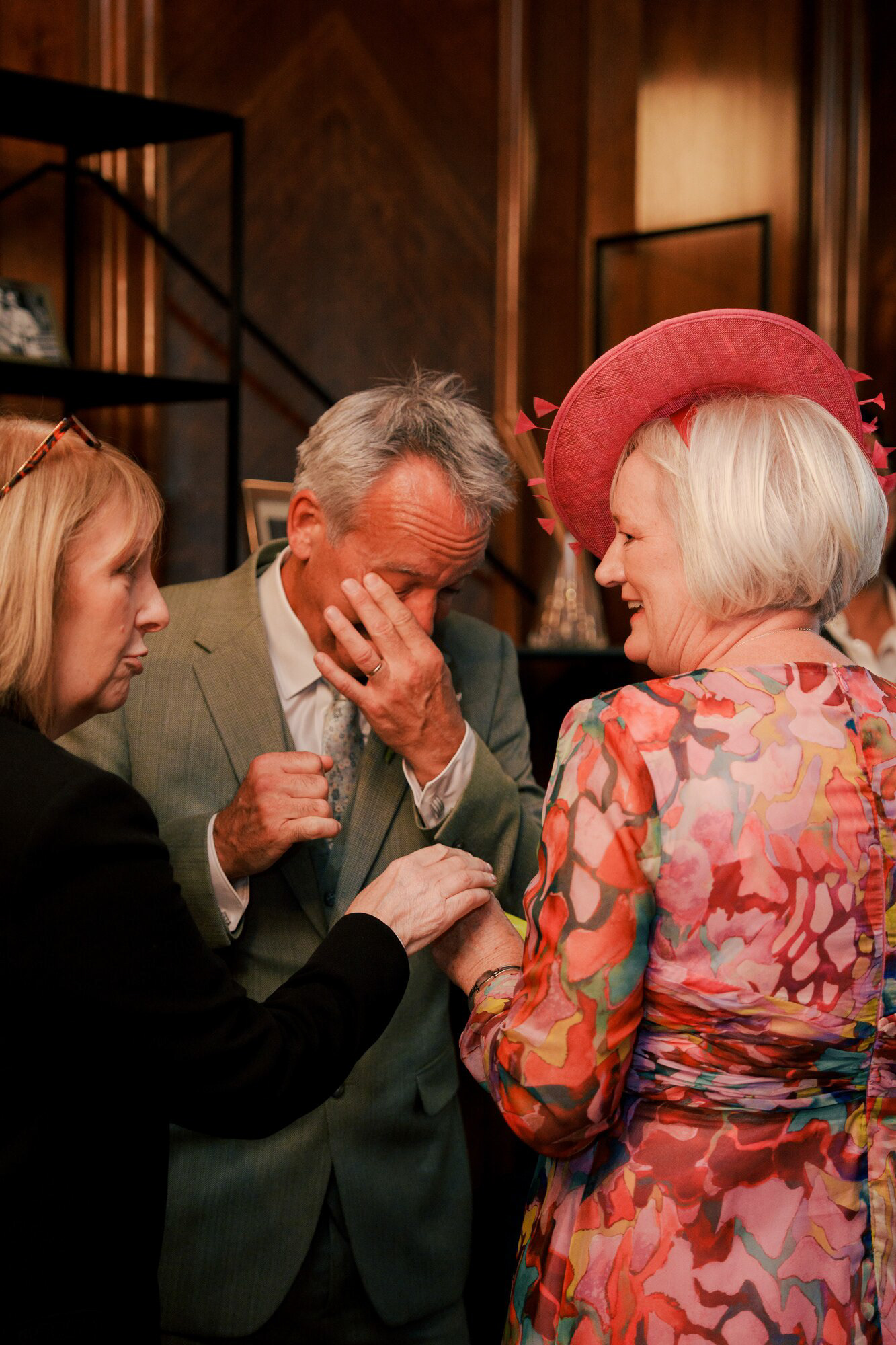 Wedding guest wiping away a happy tear after the ceremony at Old Marylebone Town Hall