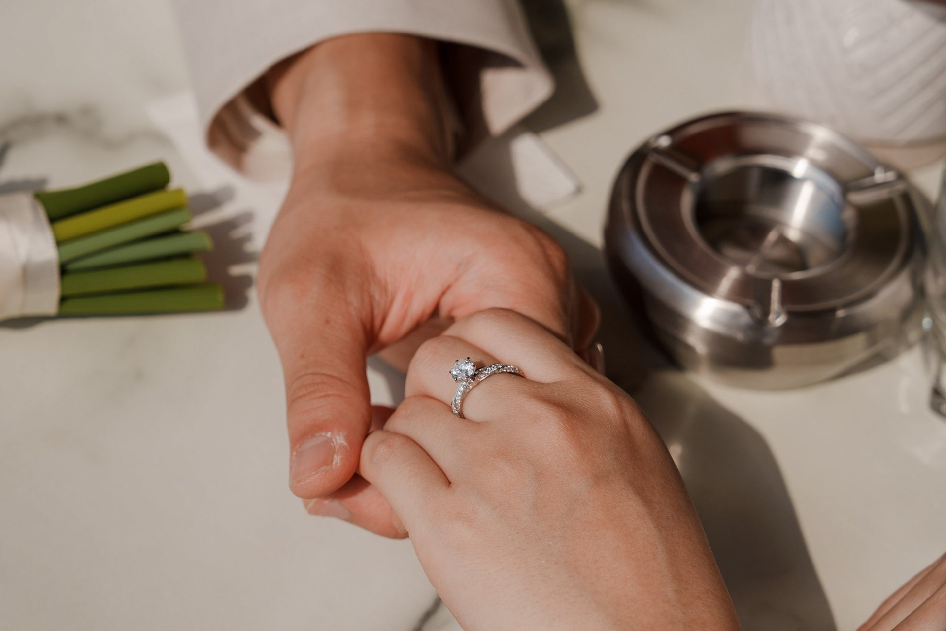 Close-up of the engagement ring at a café table, one day after the proposal
