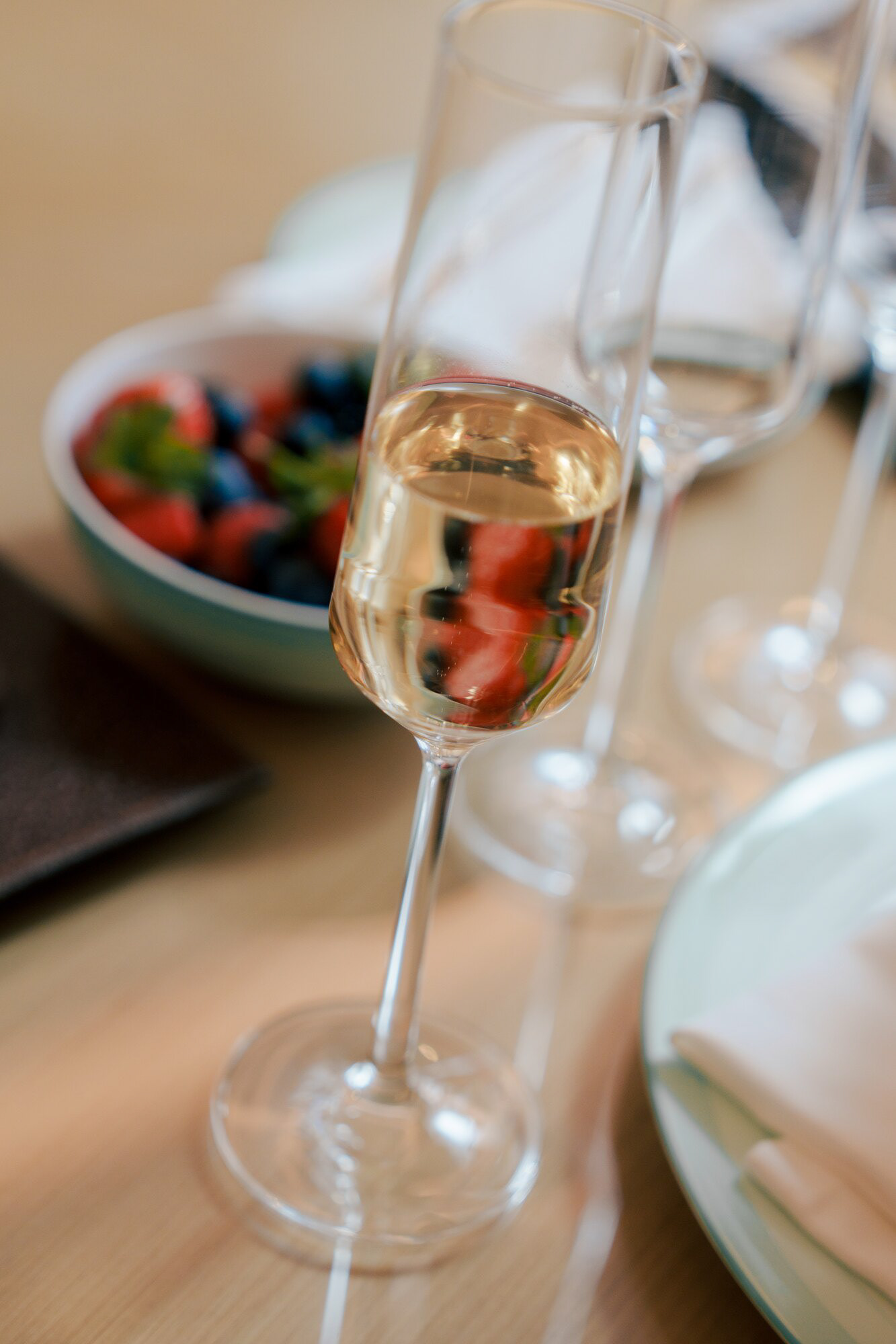 Glass of champagne and a bowl of berries during wedding morning preparations at Claridge's