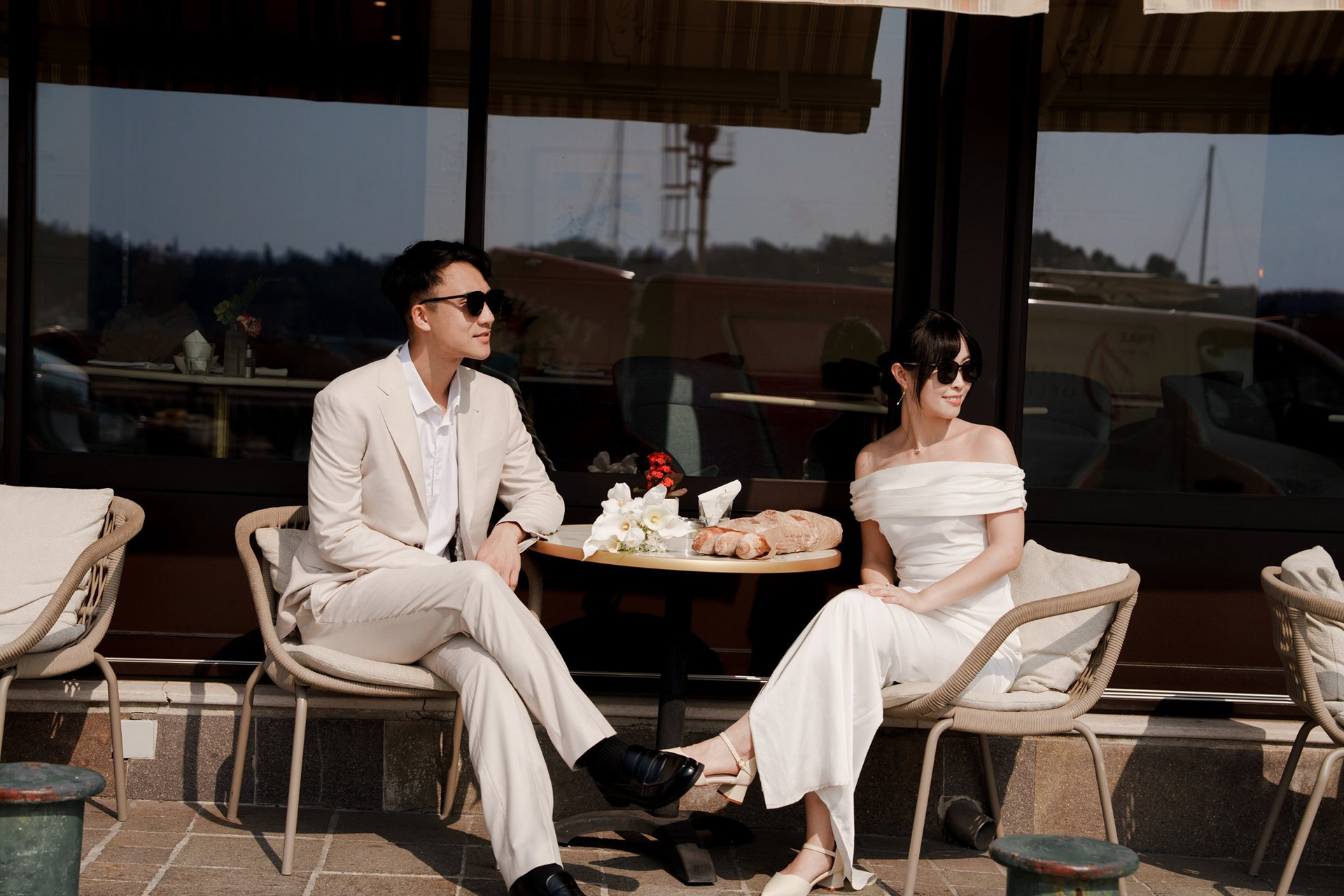 Coffee on a café terrace, both in sunglasses