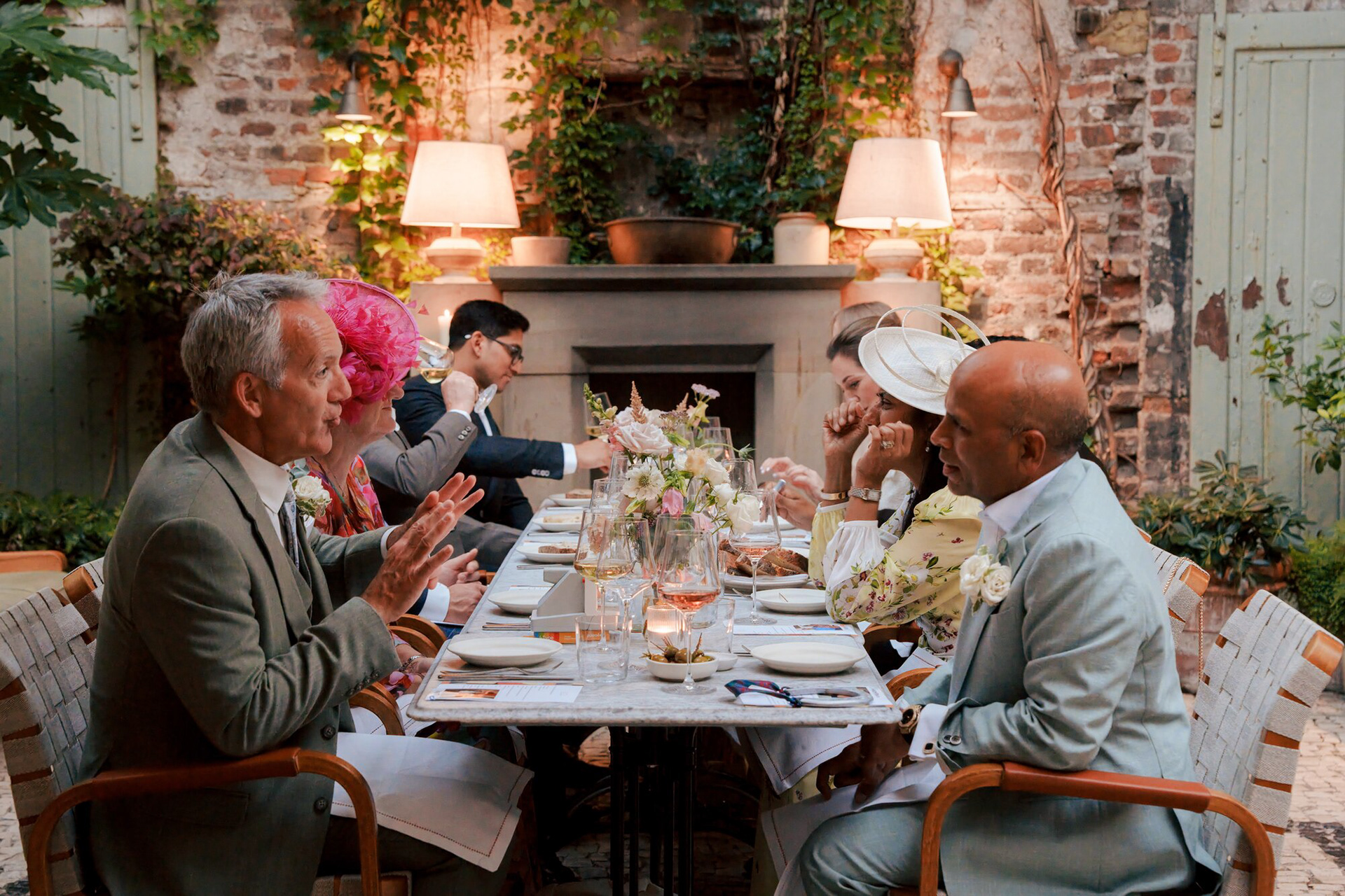 Family and friends at the long wedding dinner table in Luca's courtyard, Clerkenwell