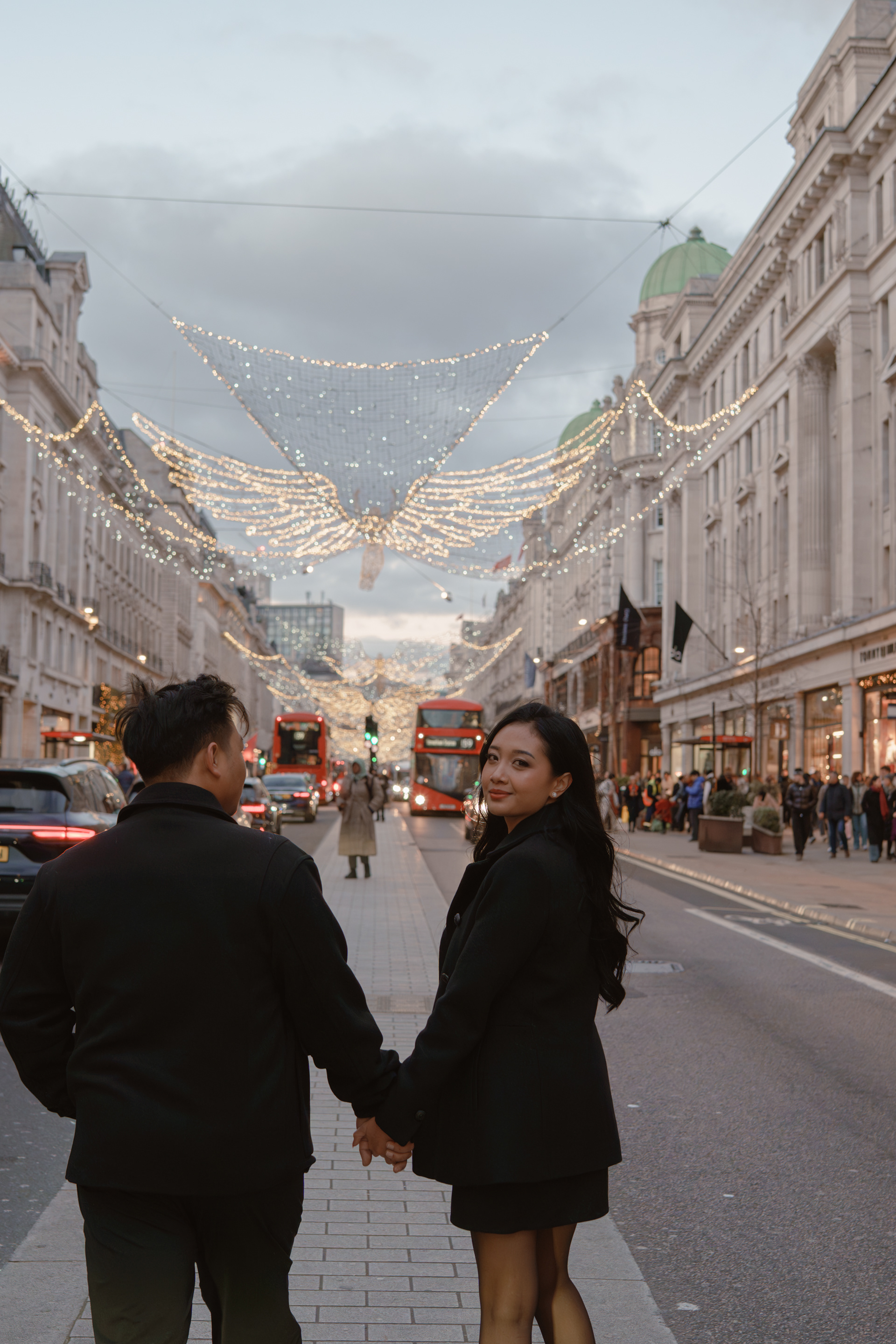 Couple portrait session under Christmas lights on Bond Street, London