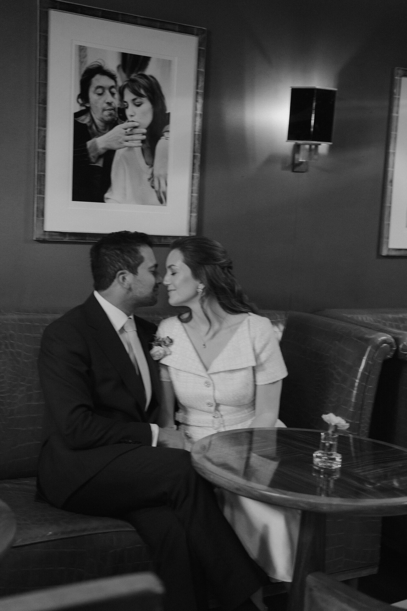 Black and white photo of the bride and groom sharing a quiet moment in a lounge at Claridge's
