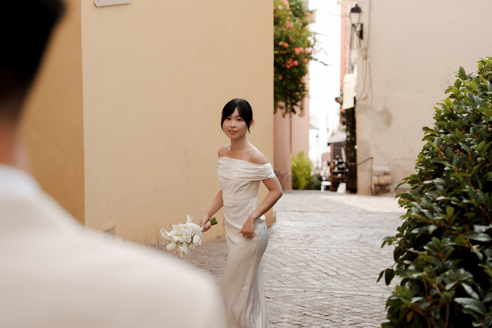 Bride walking down a narrow cobbled street in the old town