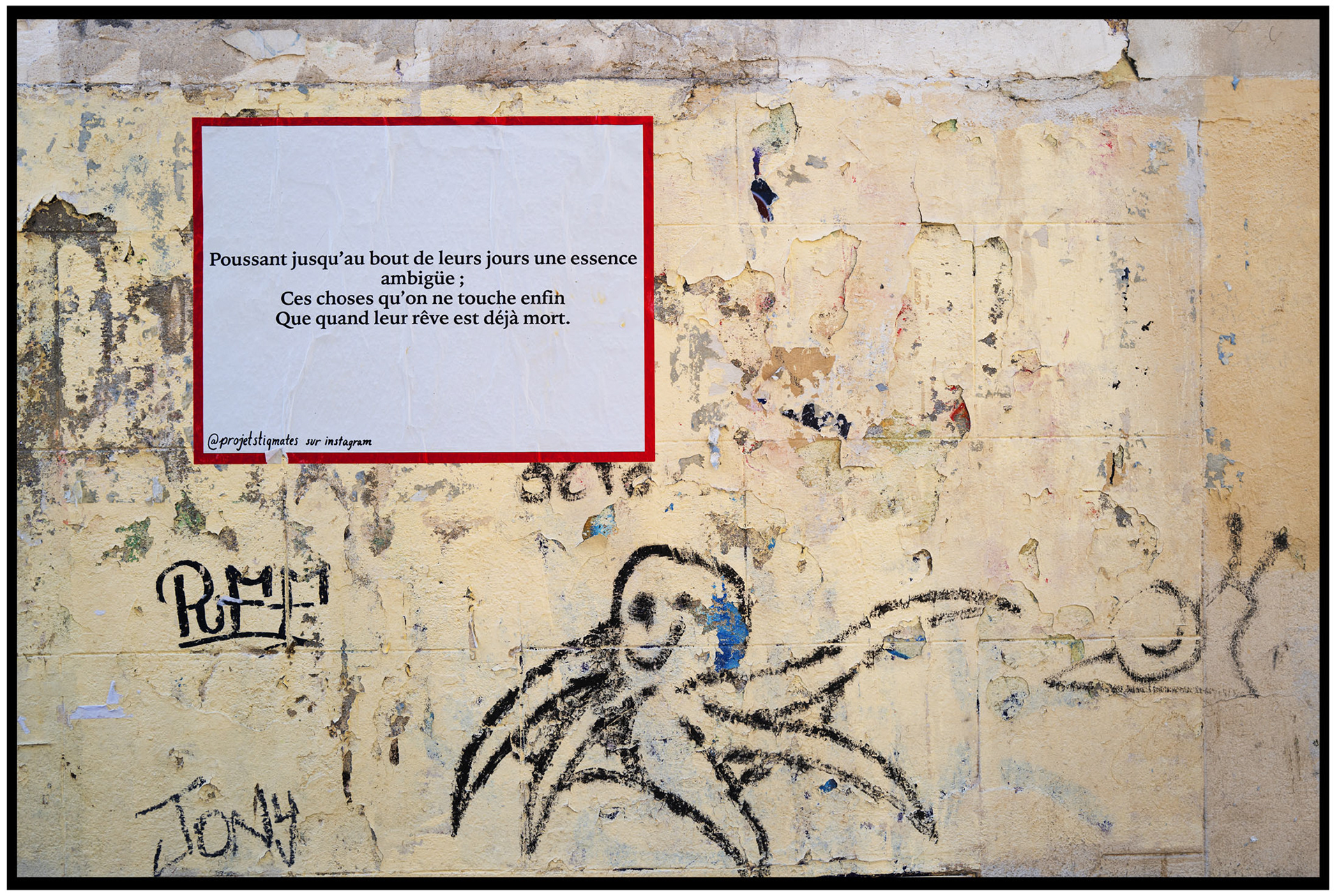 Mur à Paris avec un poème encadré et un dessin de poulpe, représentant l'art de rue.
