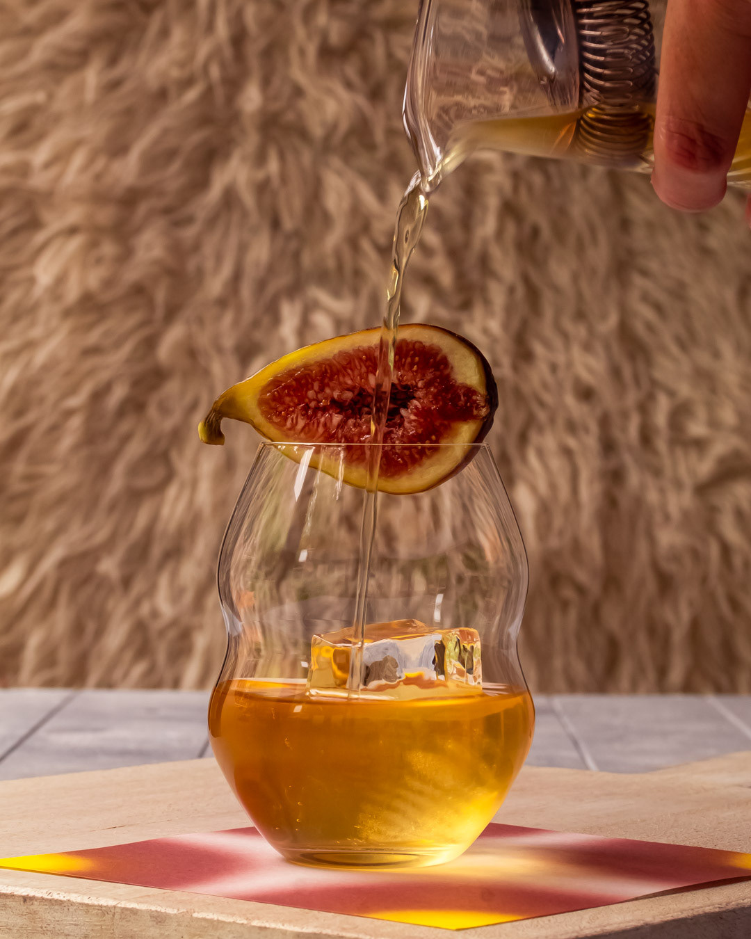 pouring fig negroni signature cocktail