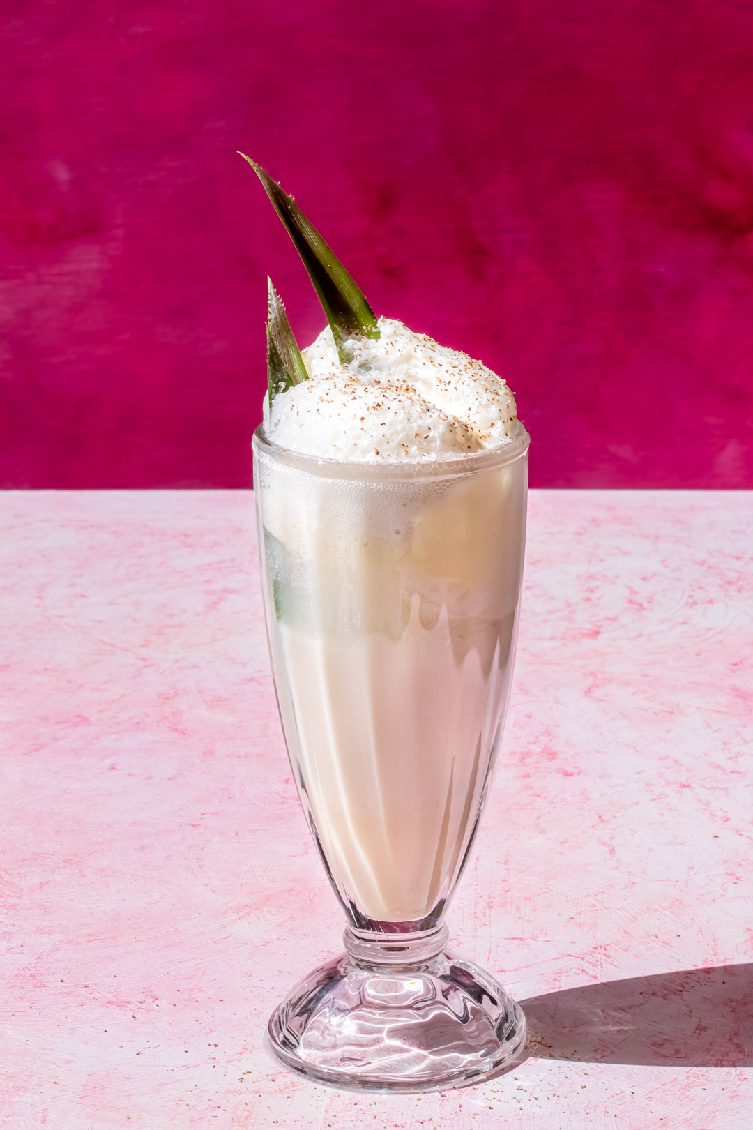 pineapple pistachio cream lactart vintage style fancy soda with pineapple leaf and freshly grated nutmeg