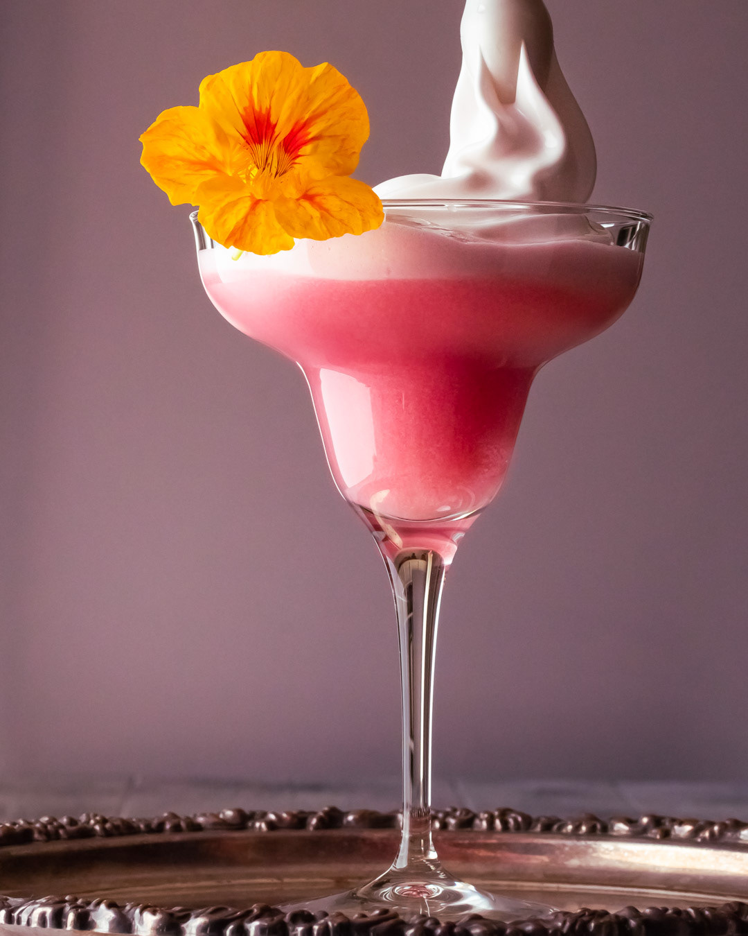 adding foam to strawberry and orange bespoke sour cocktail