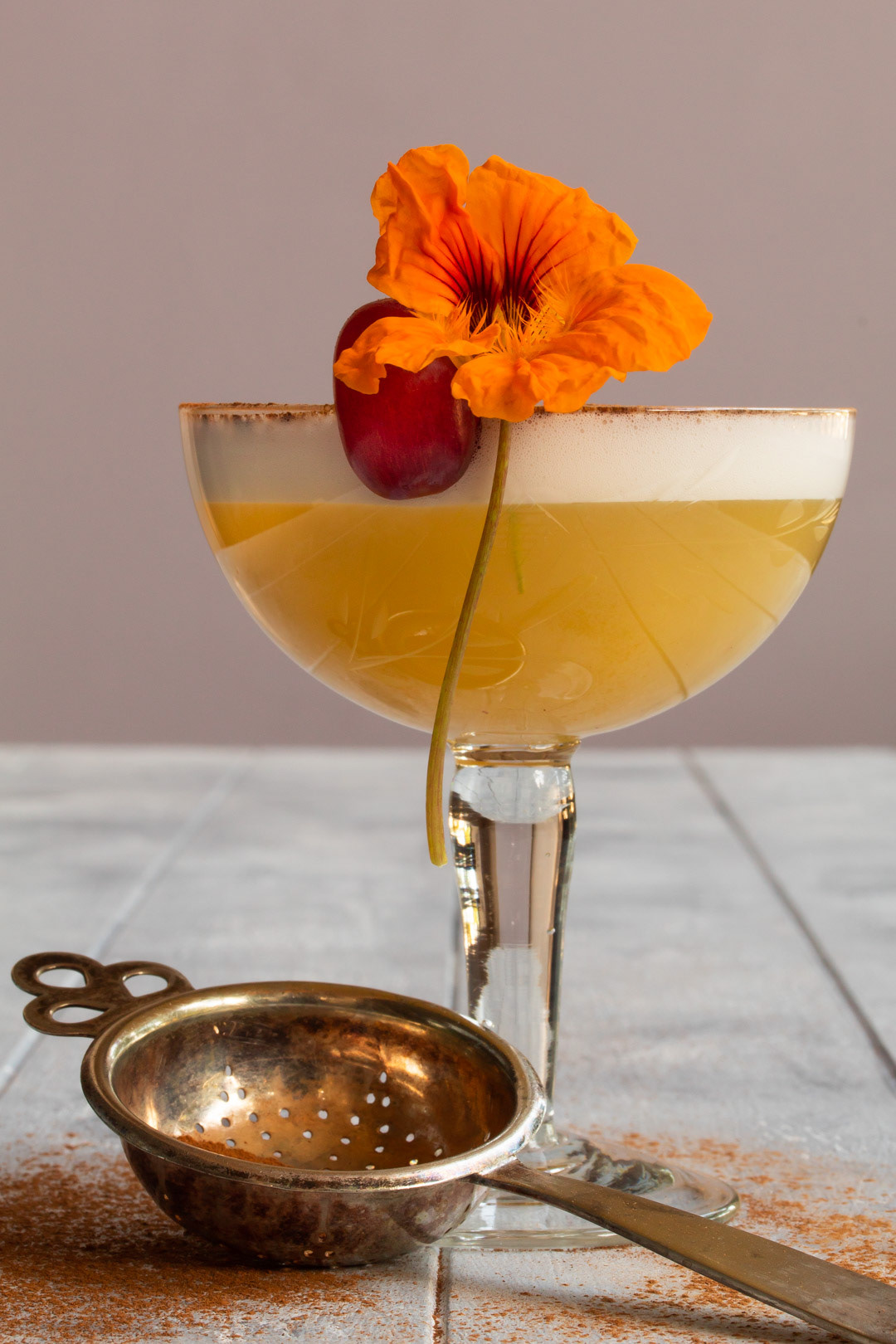 Autumn grape shrub silver sour with nasturtium flower and grape garnish