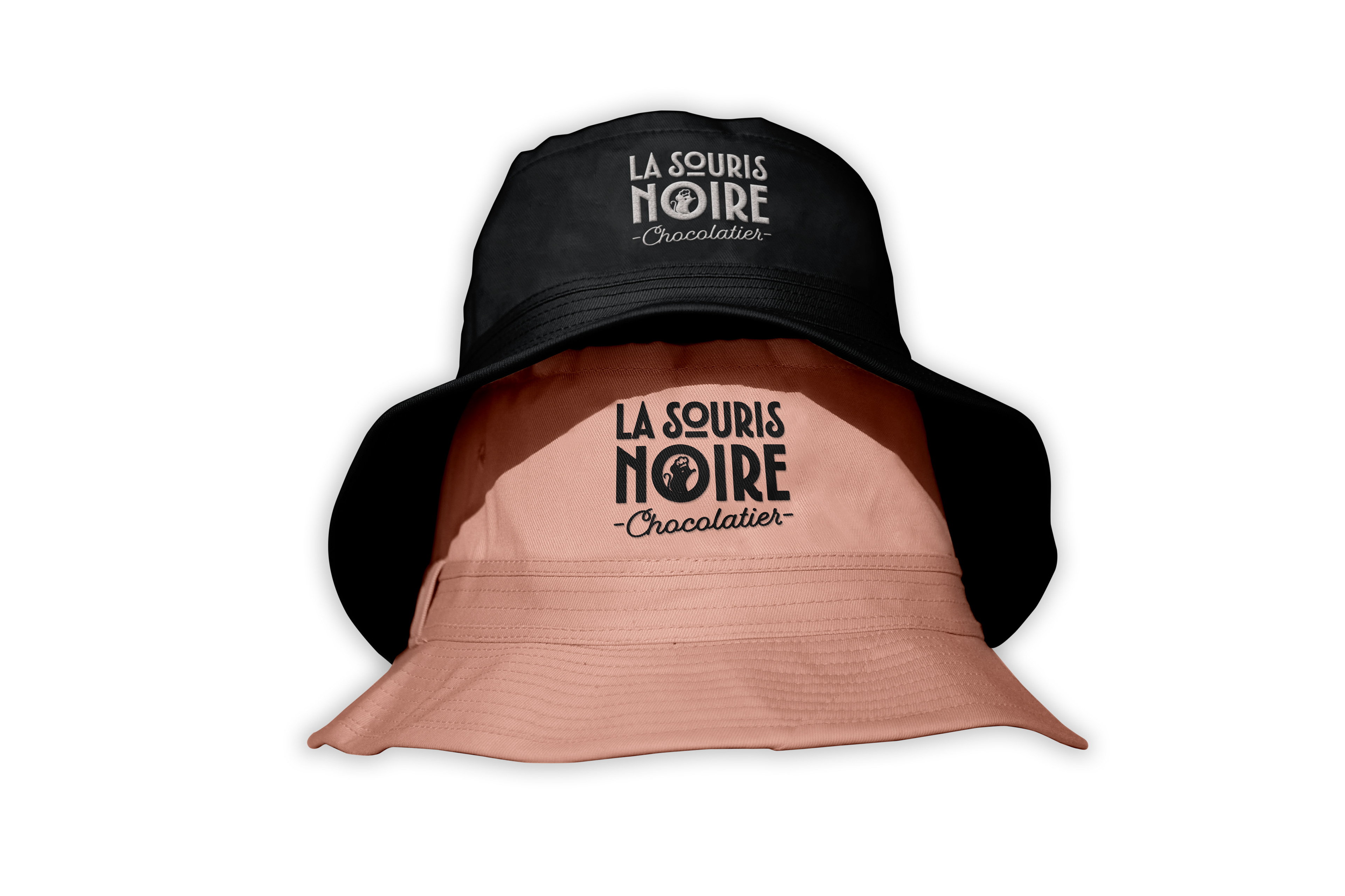 Mockup of Two Bucket Hats with the La Souris Noire Logo Embroidered