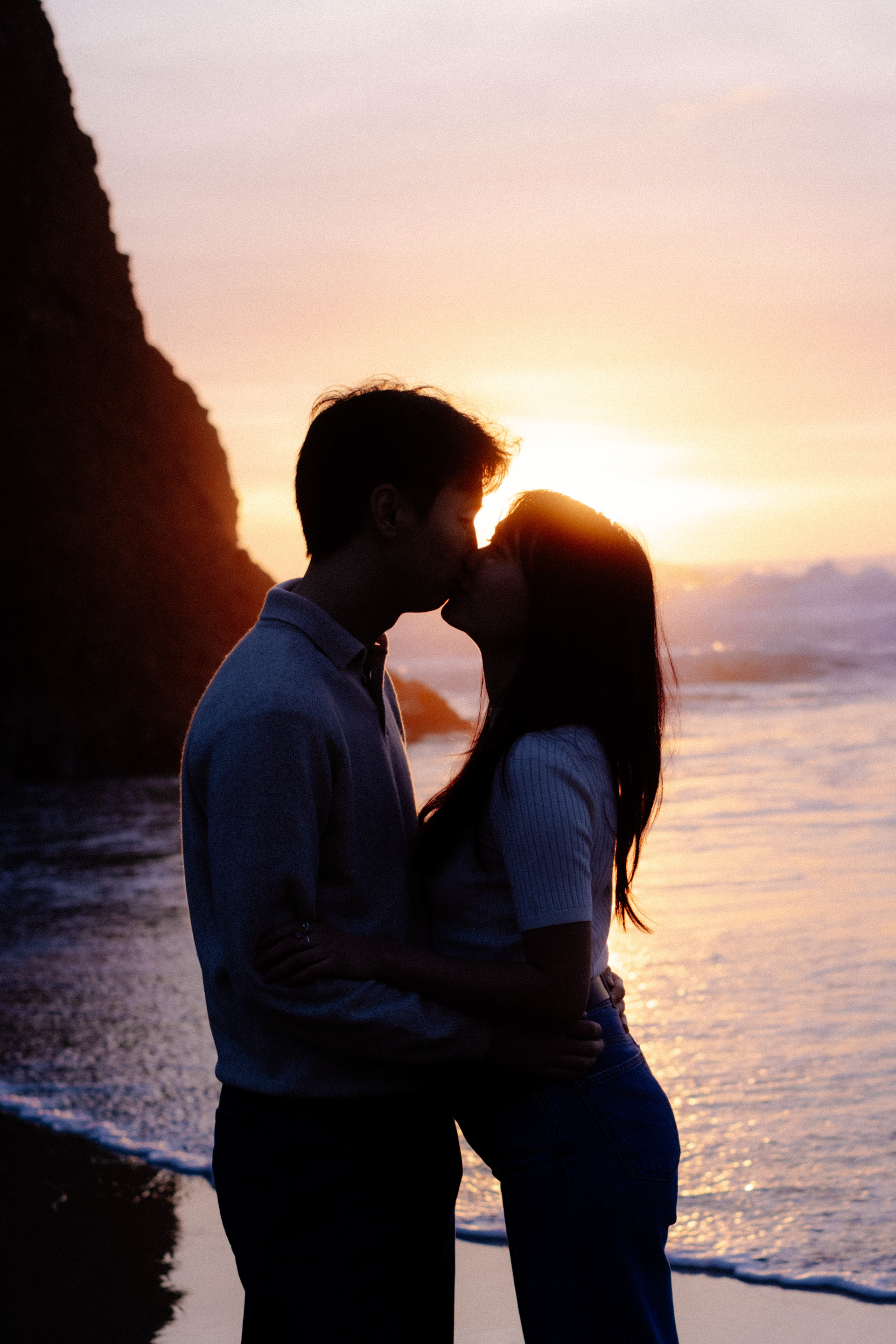 Couple kiss on a beach at sunset, Portugal