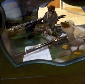 Puppets and their musical instruments inside the bench