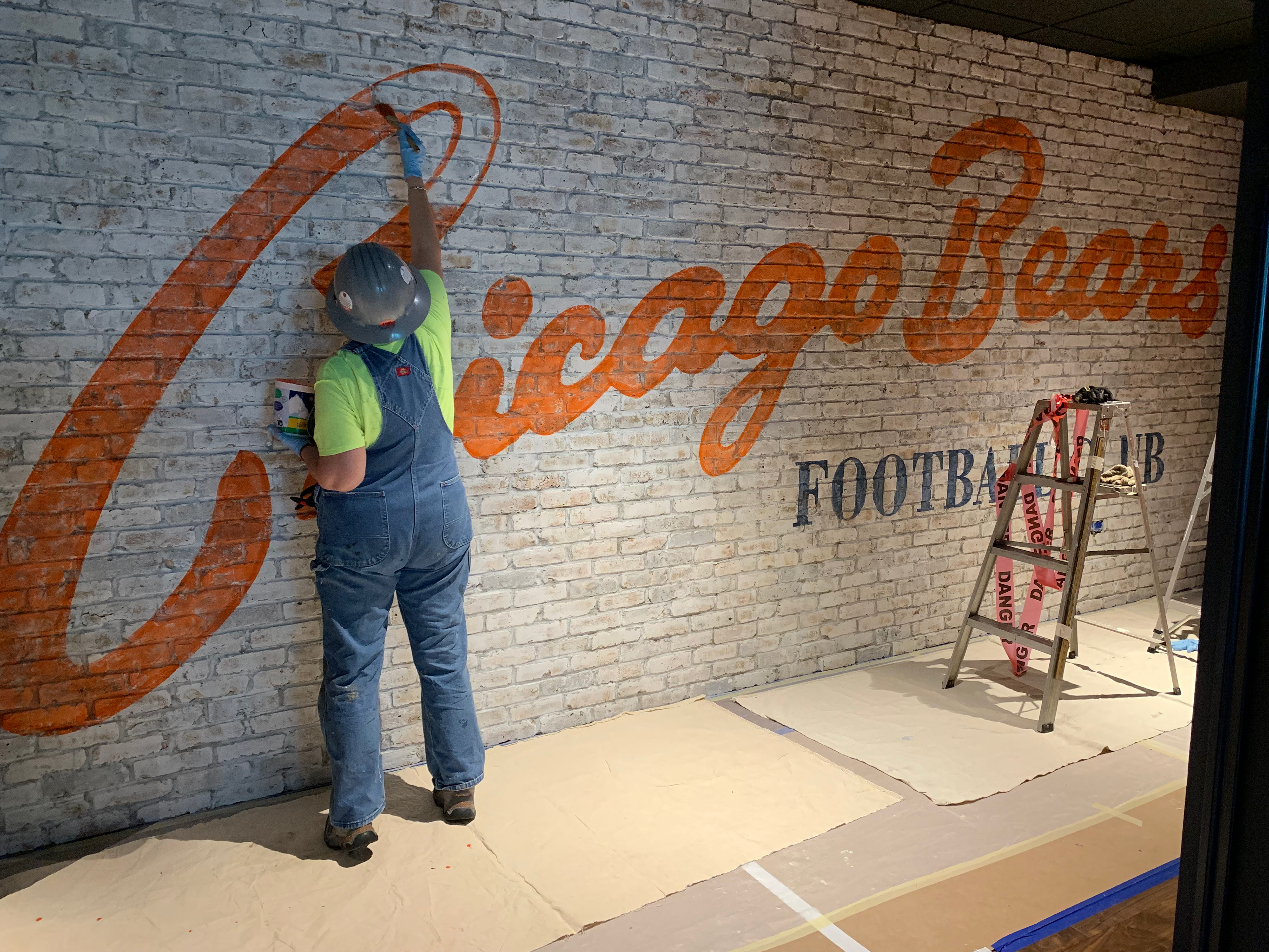 Painting a "ghost sign" for the Chicago Bears.