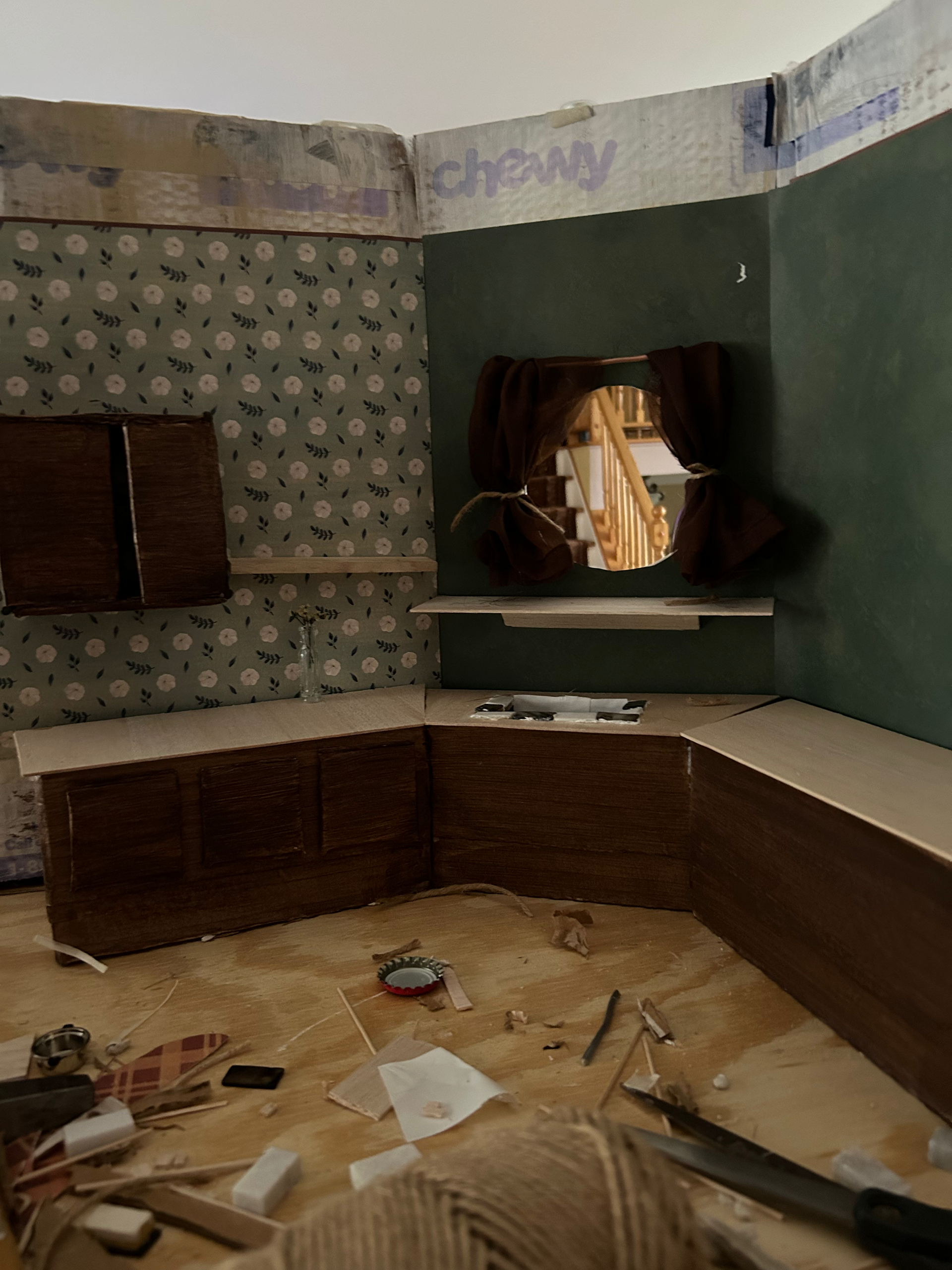Set build out of old cardboard boxes, cabinets painted to look like wood, countertops made from balsa wood