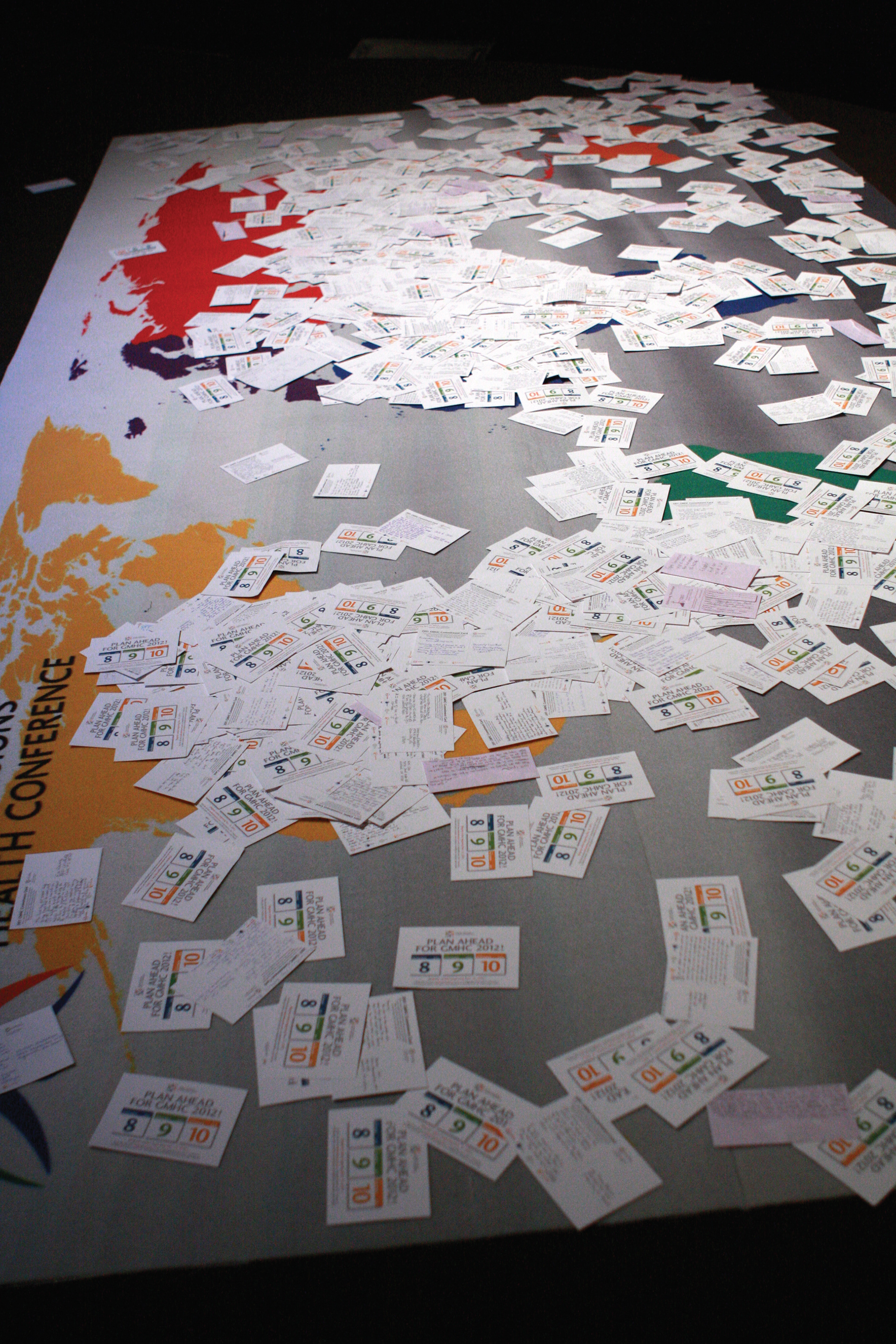 Giant Floor Graphic Map of the World Used During Another Commitment Engagement: Attendees Fill Out a Postcard and Lay it on the Map