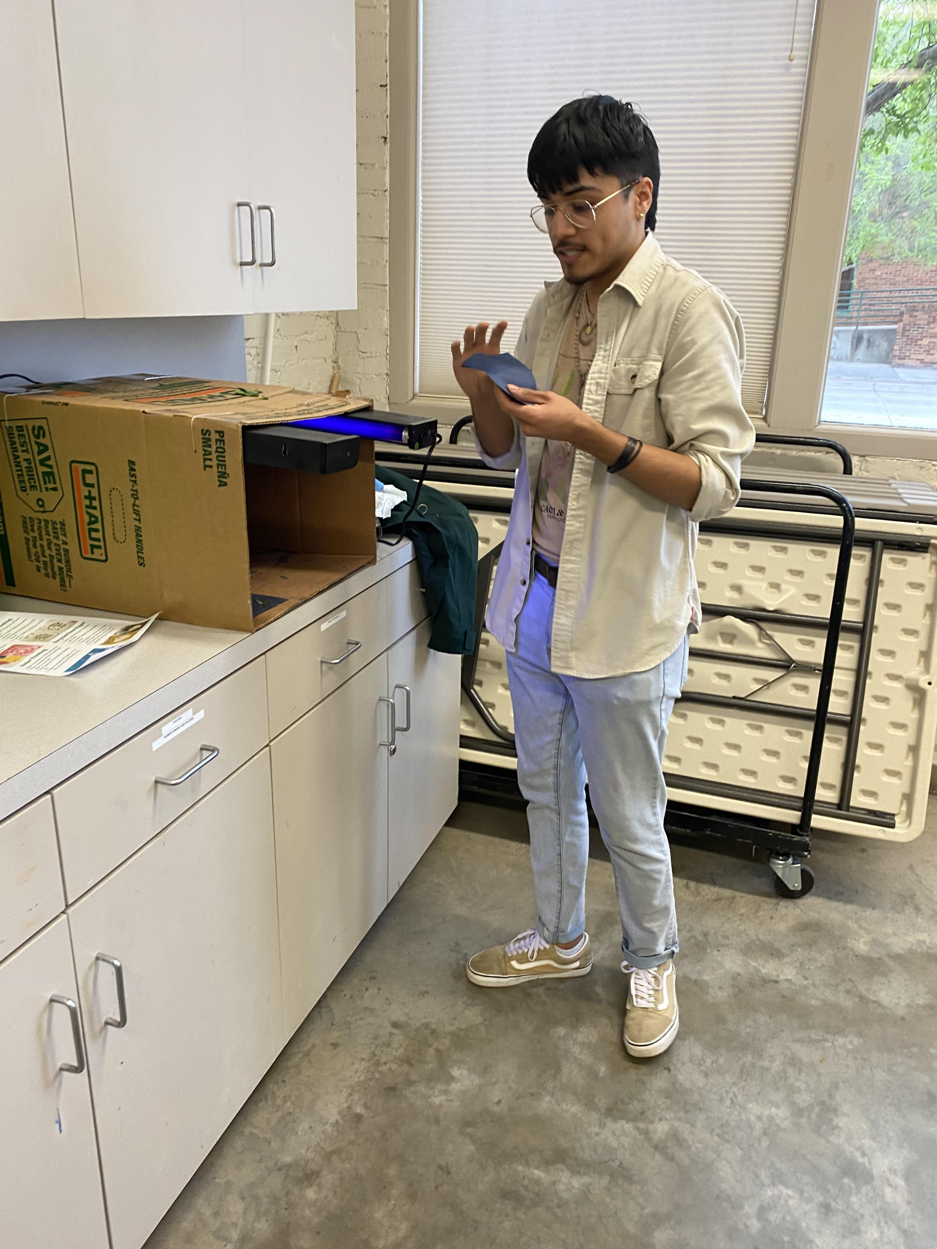Student Jonathan DeLaCruz demonstrating infrared light curing