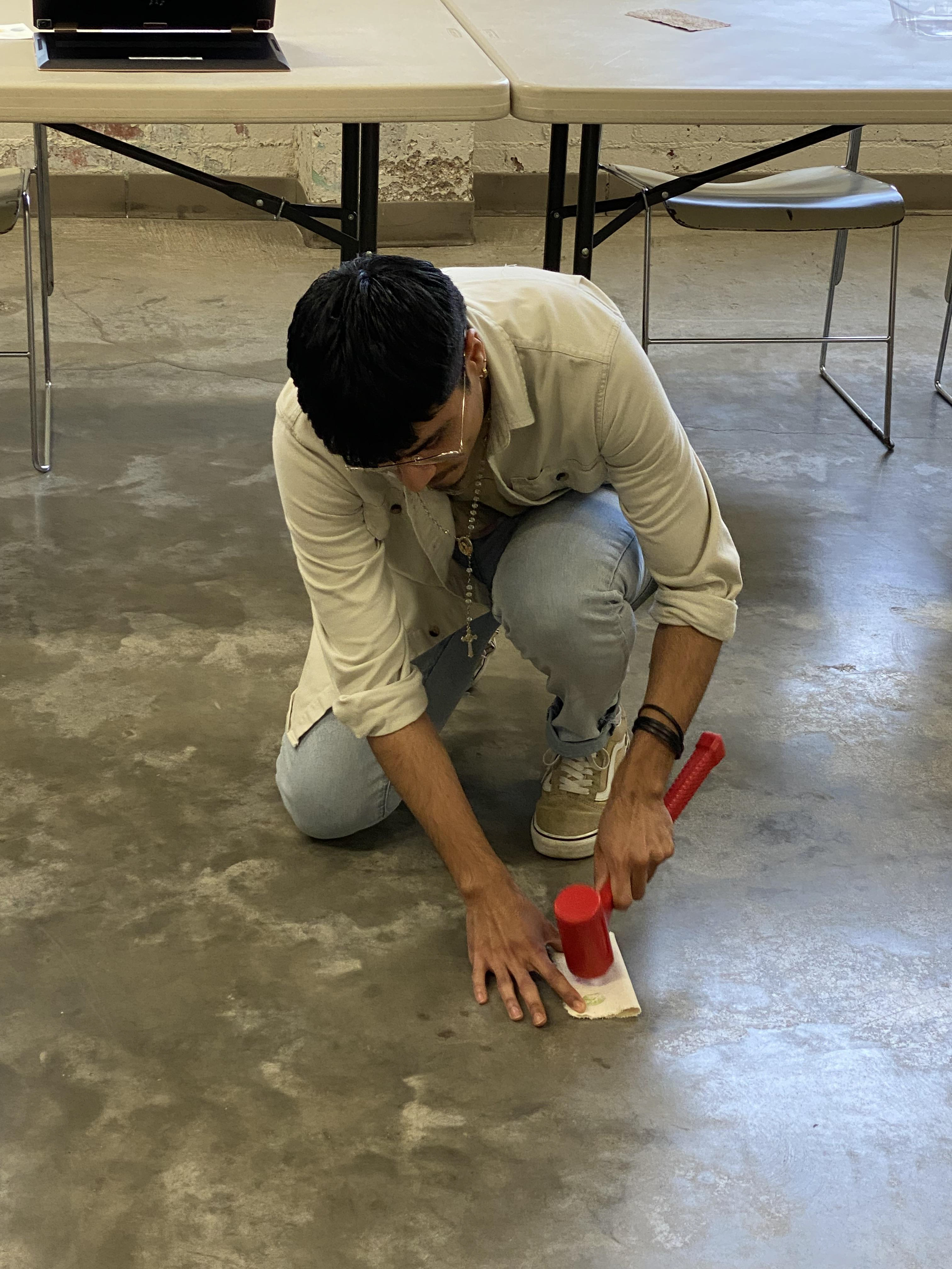 Student Jonathan DelACruz demonstrating flower pounding