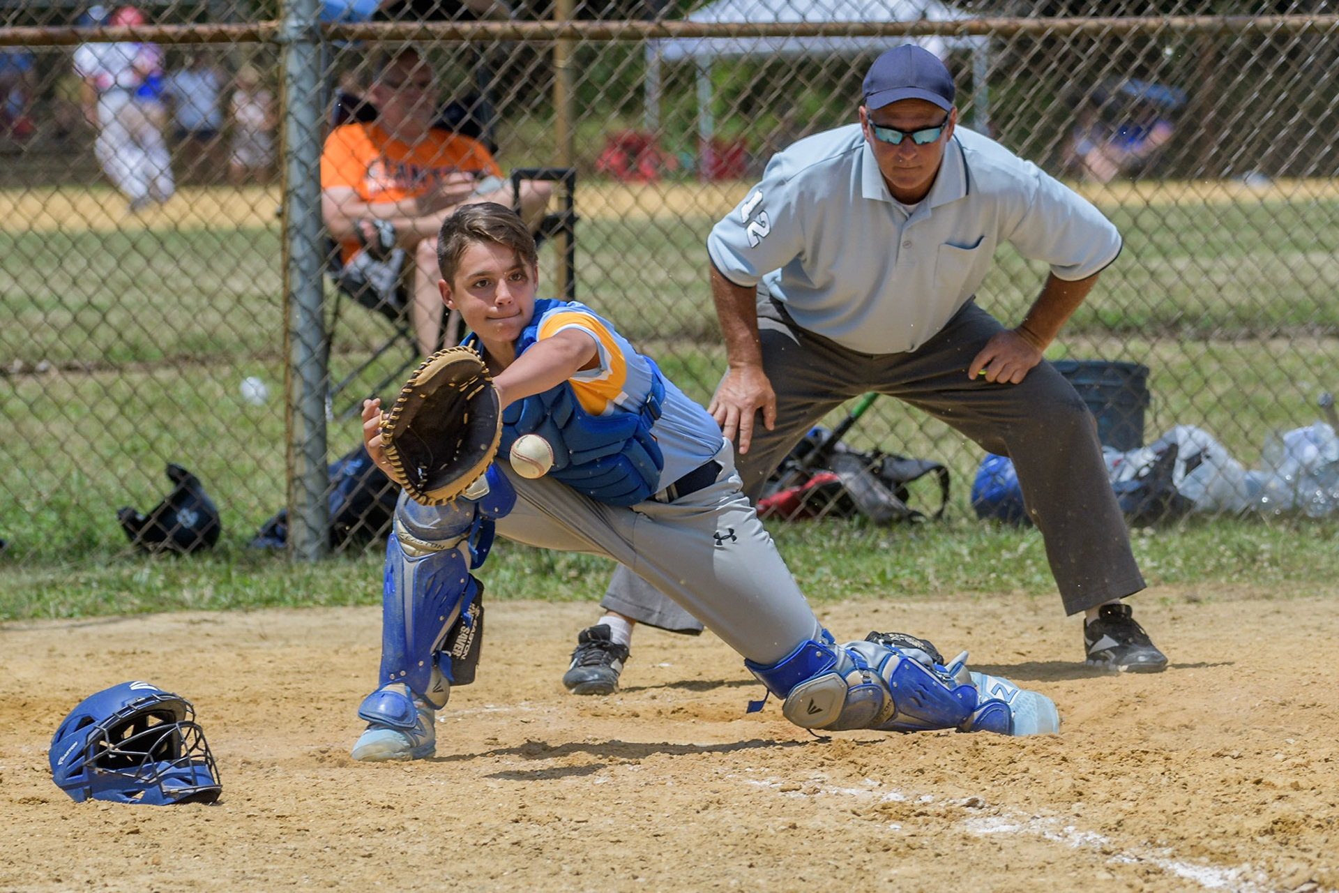 Alex, 13, of the Young Guns Pride, reaches for an incoming ball as he prepares to tag the runner out at home during the Killer B tournament, at the MYAA Sports Complex in Medford, NJ.