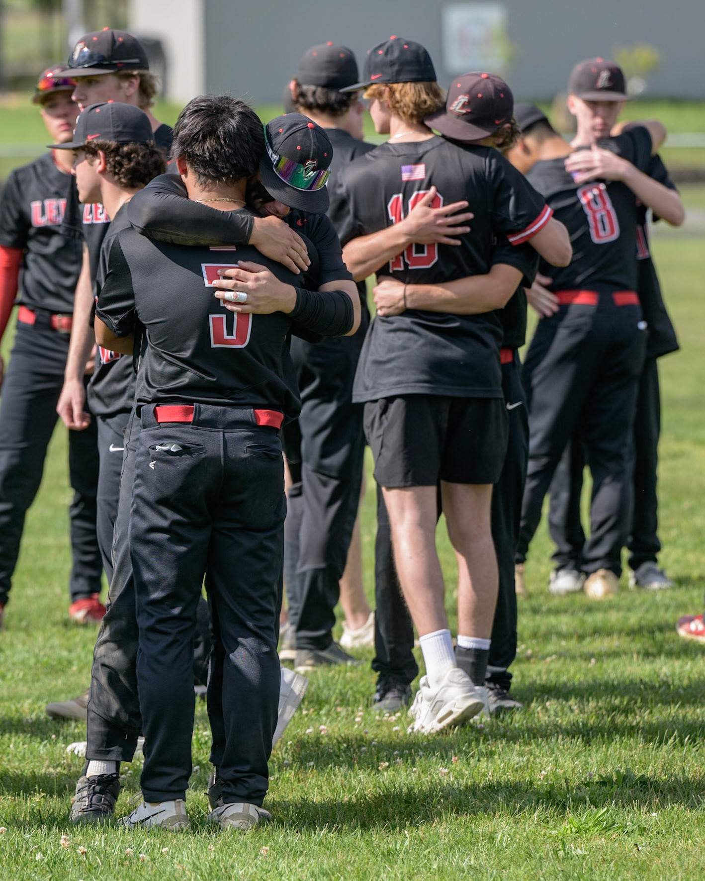 Members of the Lenape High School baseball team hug after their last game of the season against Southern Regional High School. (Photo by Brian Barbash/gametimedreams.com)
