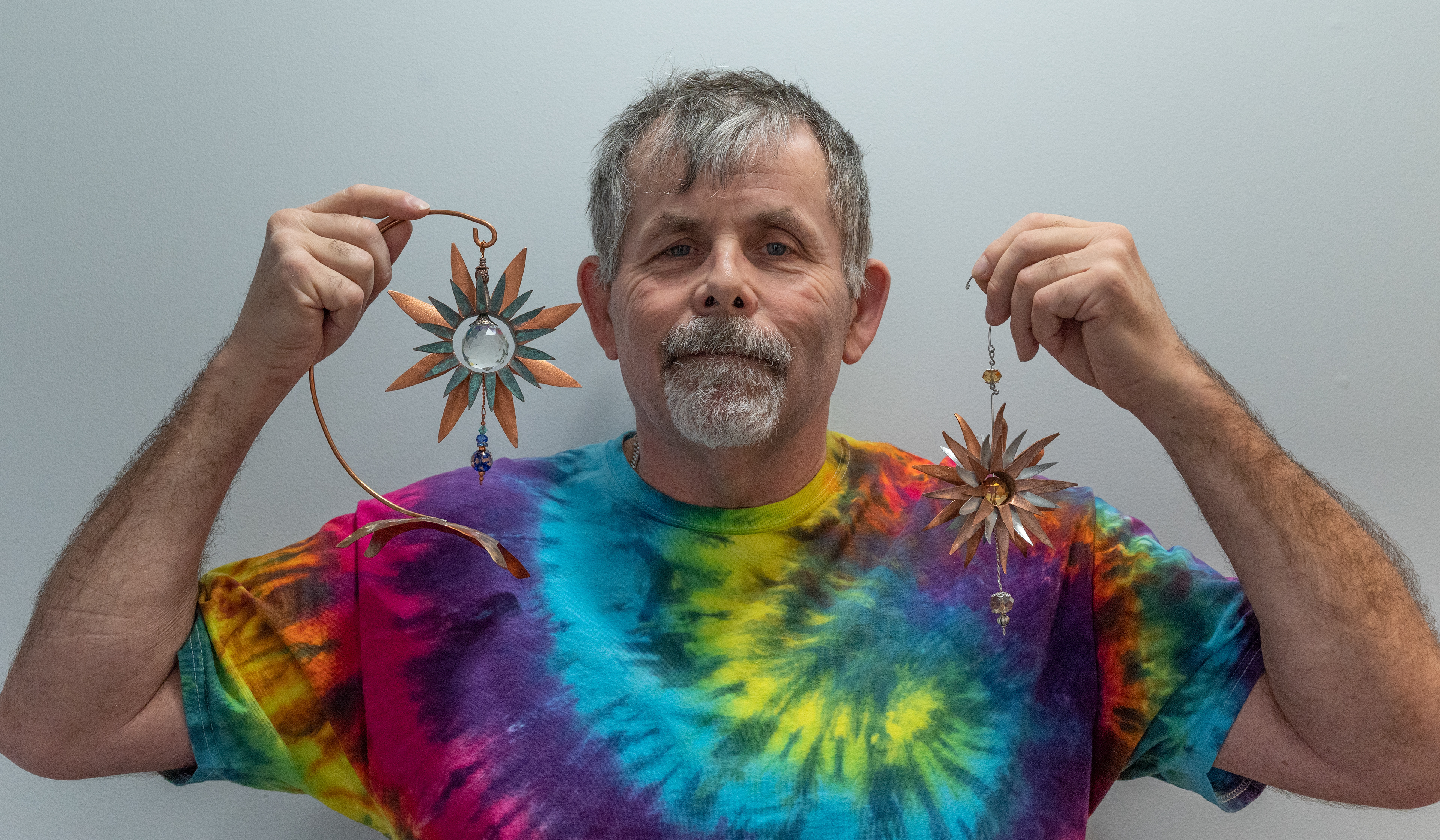Marty Borsboom holding 2 of his copper creations.