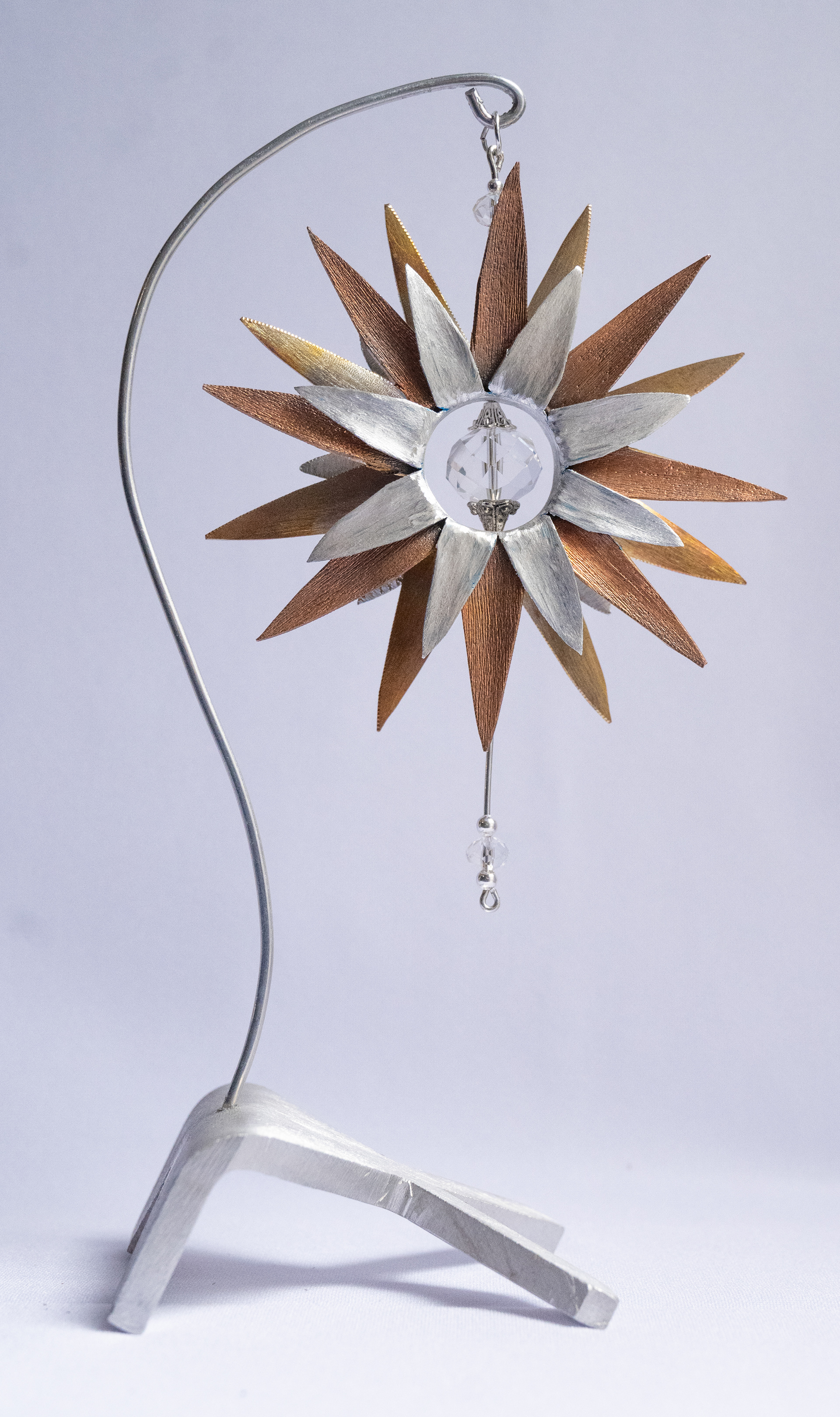 "Crystal Clear" , 3.5w x 8h x 3d, has a copper and aluminum flower with crystal centre on an aluminum base, $125