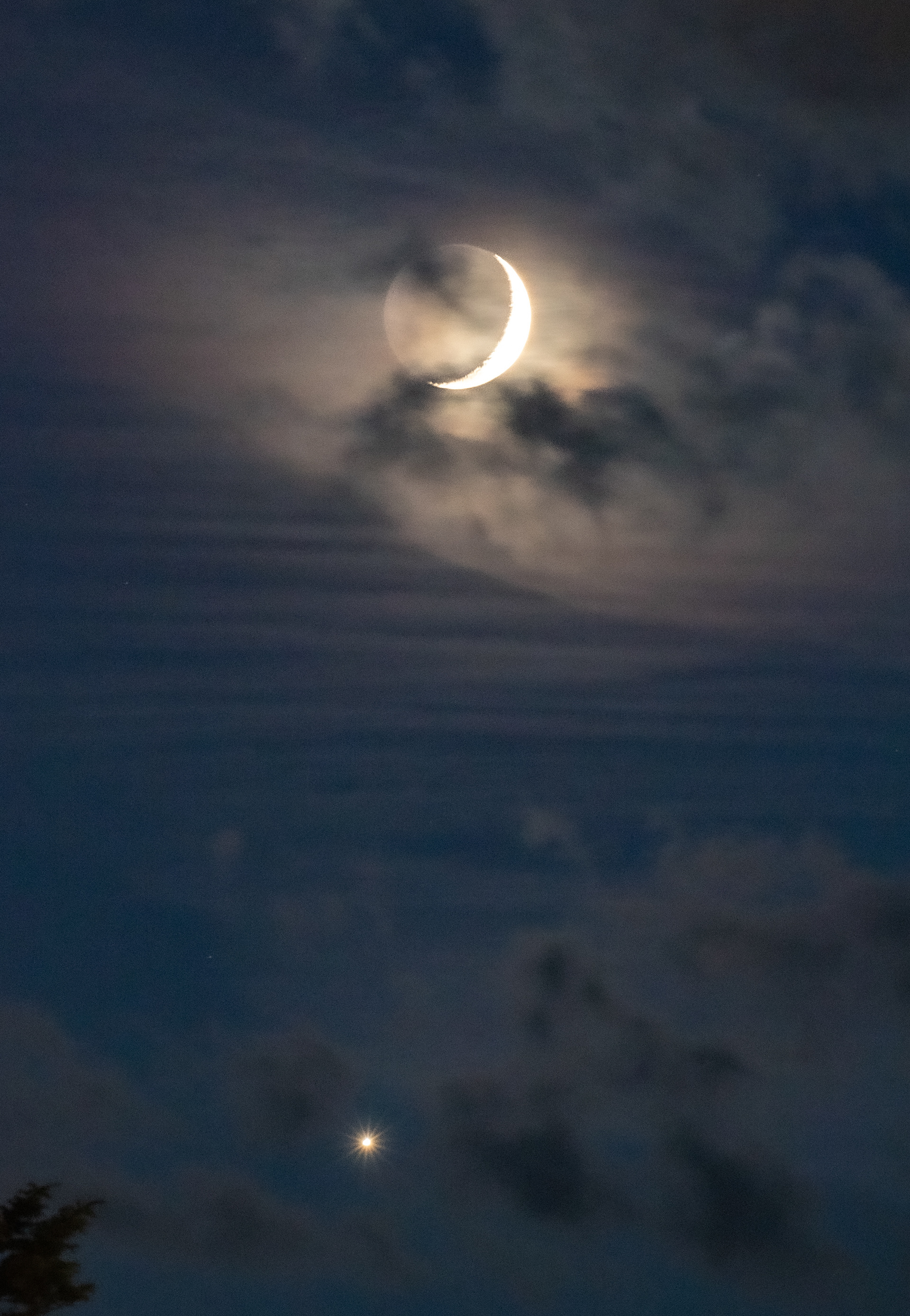 Crescent moon with earthshine and Venus below.