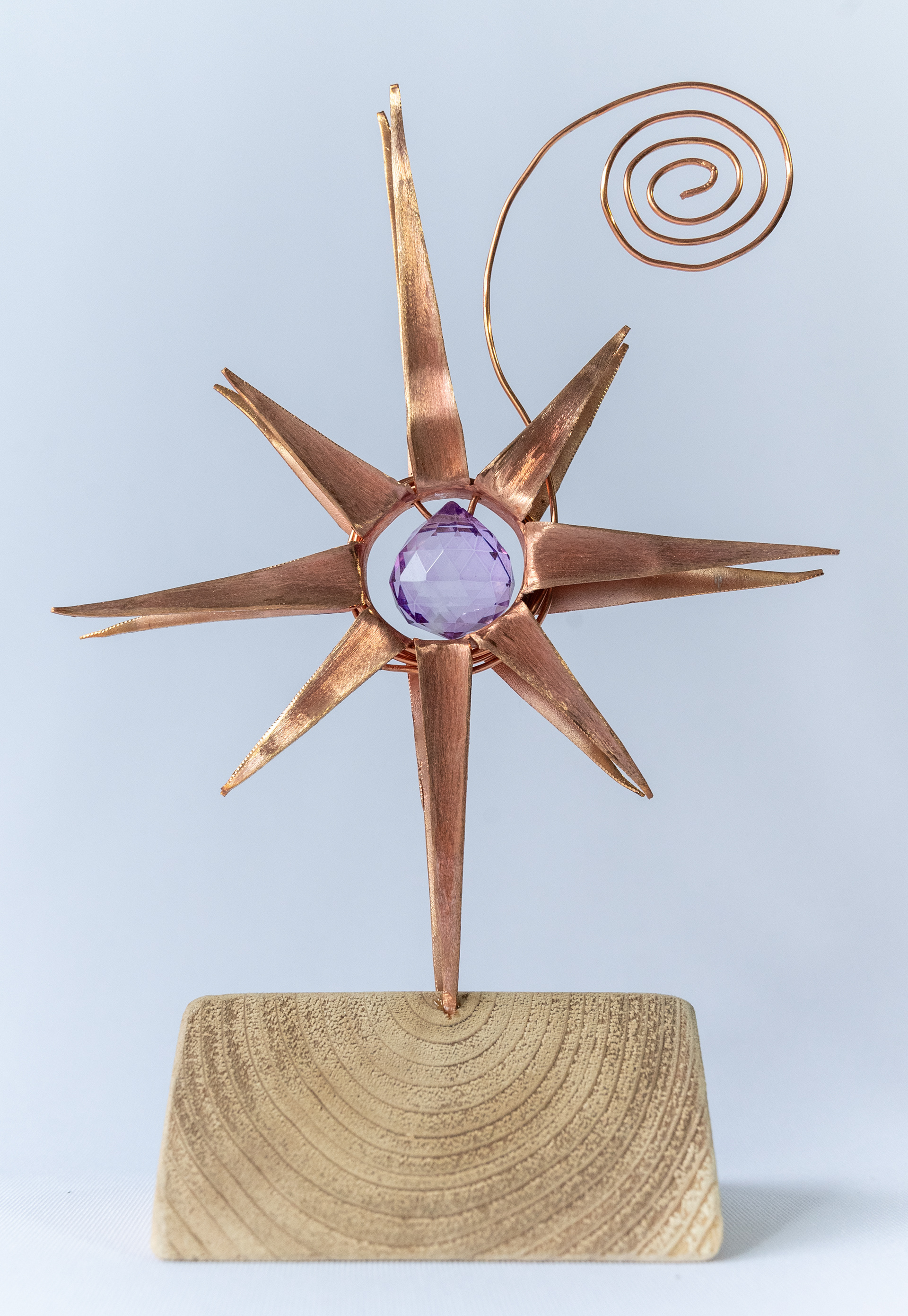 "Star Gazer" features a hand cut and shaped copper flower on a wood base, with a purple glass crystal centre, 5 inches wide x 7.75 inches high x 3 deep, $125
