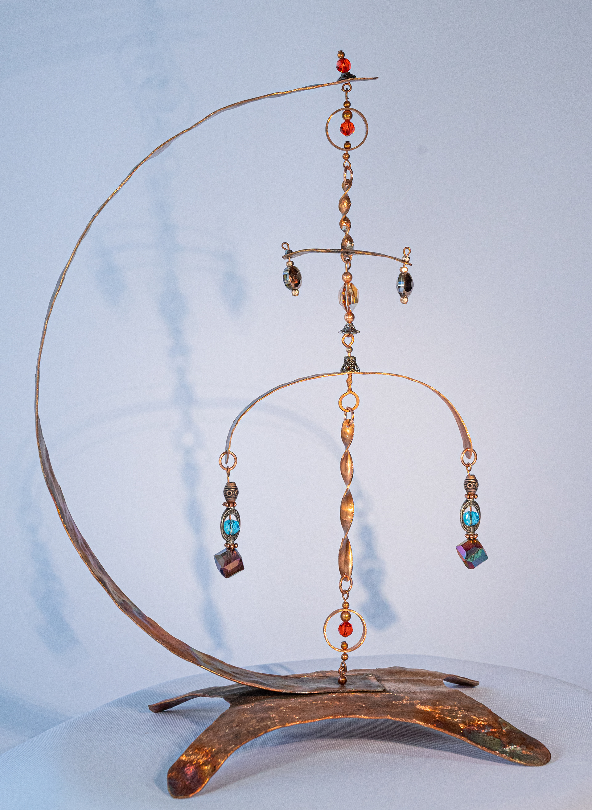 "Spinner"  is hammered copper and hand twisted copper on a copper base with multi coloured crystal accents, 11 inches high x 8 inches wide x 5 inches deep, $125