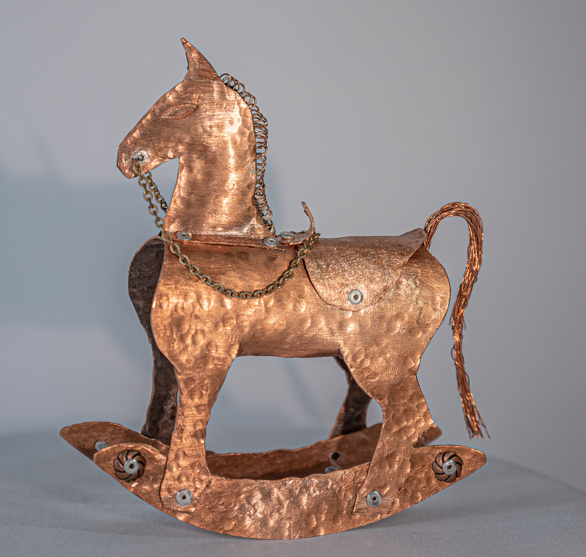 "Giddy Up" is an original one-of-a-kind copper hand cut and hammered rocking horse with brass chain and rivets, 6 inches high x 5 inches wide x 1.25 inches deep, $175