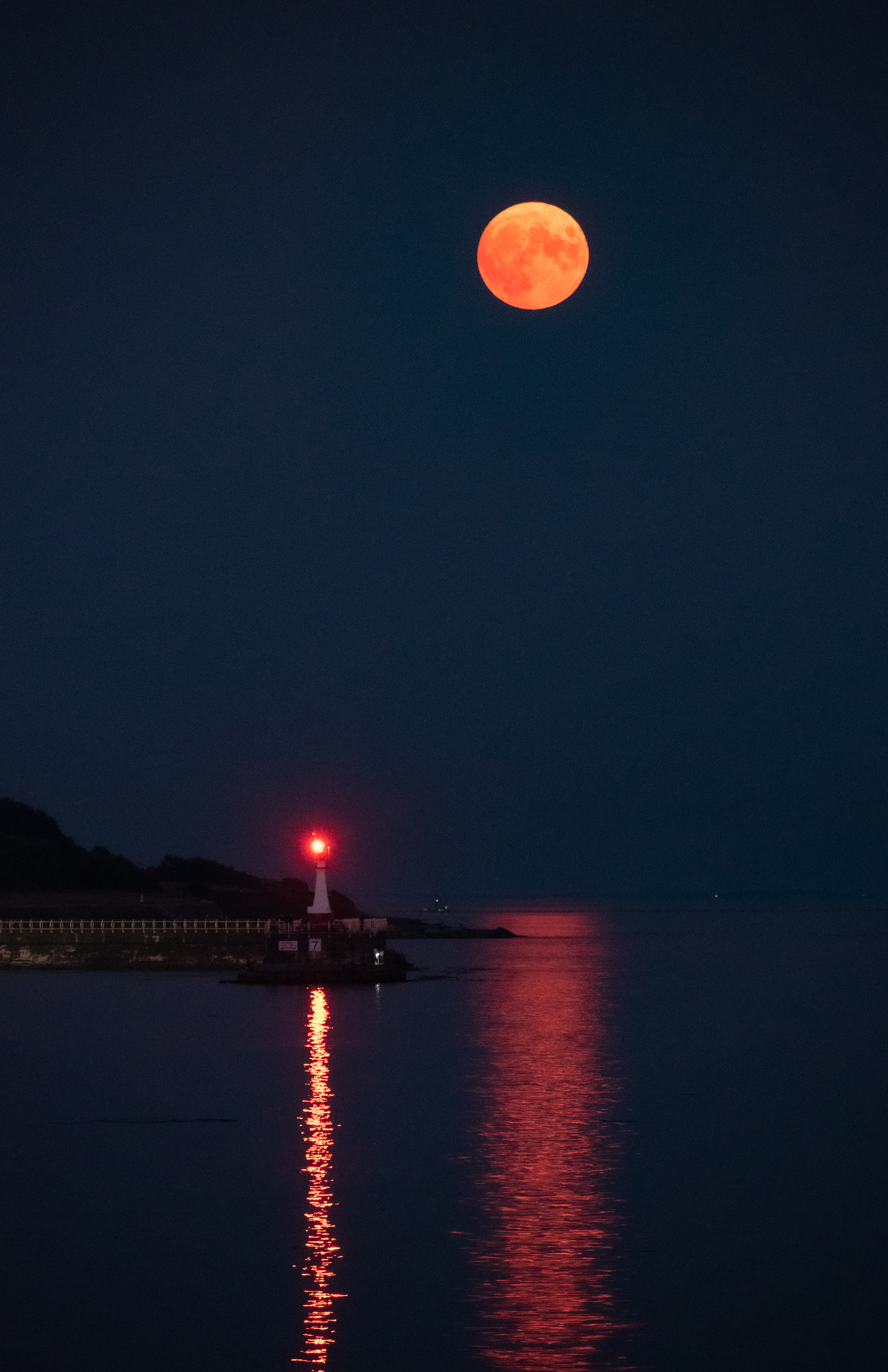 Moon over the Breakwater at Ogden Point in Victoria.