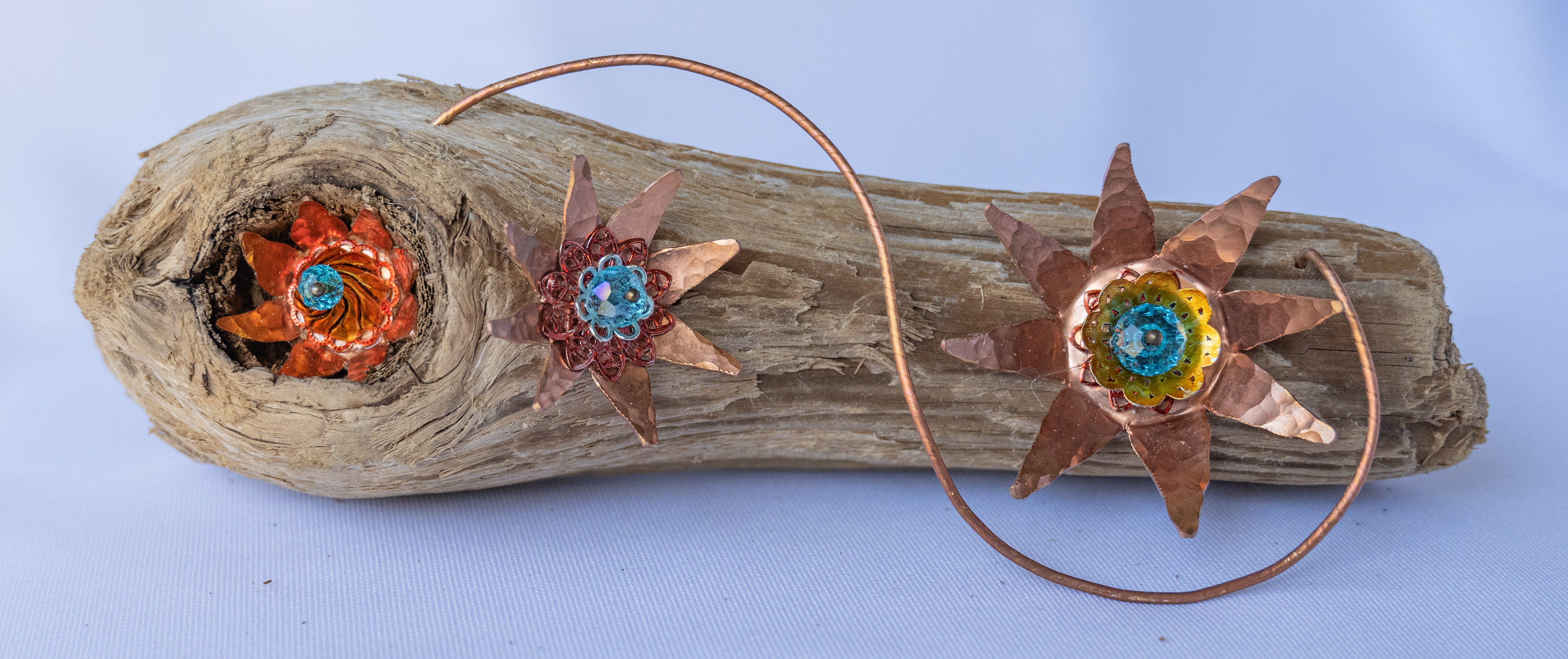 "Blue-ming' 6 x 2 x 2, has 3 copper flowers with crystal centres on Vancouver Island driftwood, $75