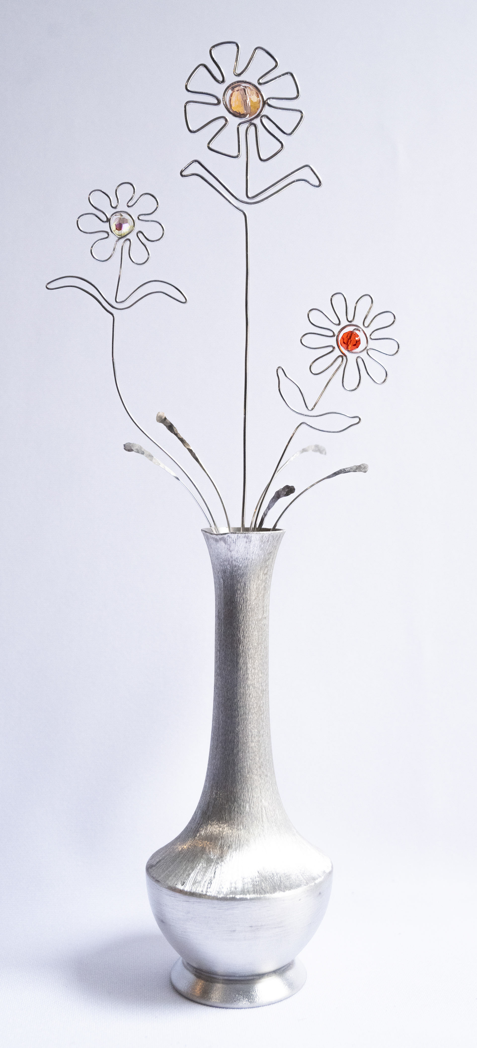 Shiny, 4.25w x 11.25h x 2.25d, Aluminum flowers with glass centres in an aluminum vase, $75