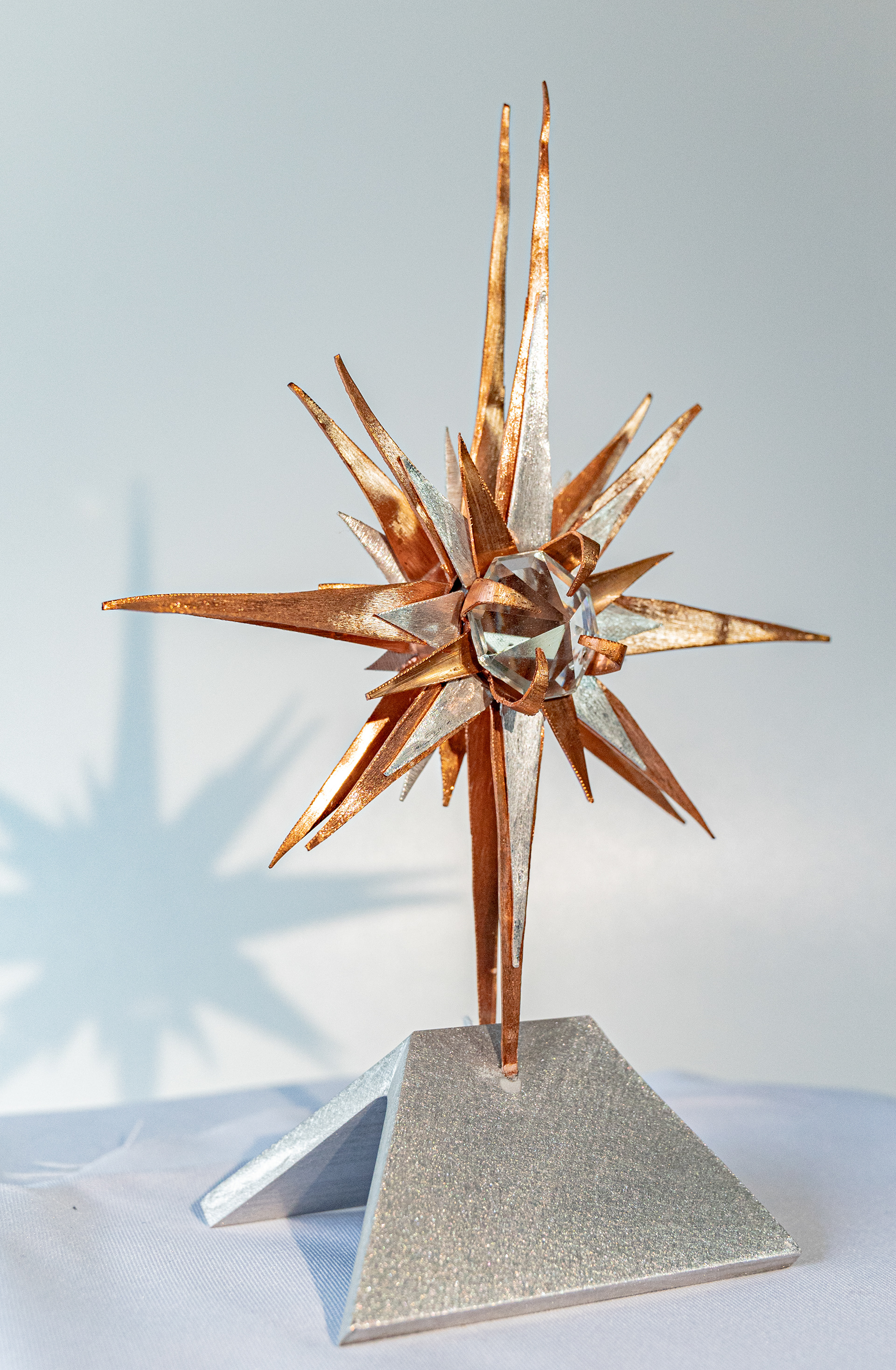 "Wish Upon a Star" (side view) is a copper and aluminum star with a clear crystal centre on an aluminum base, 5.5 inches wide x 8 inches high x 3 inches deep, $125