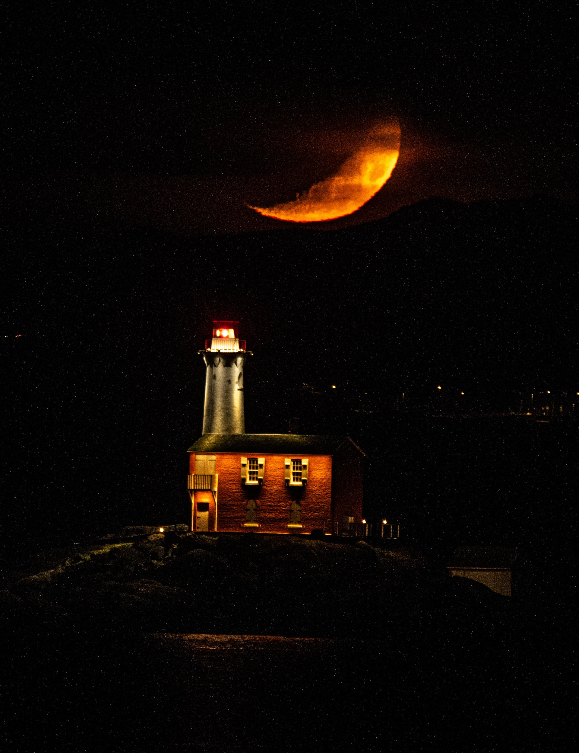 Crescent moon setting over the Fisgard Lighthouse in Victoria.