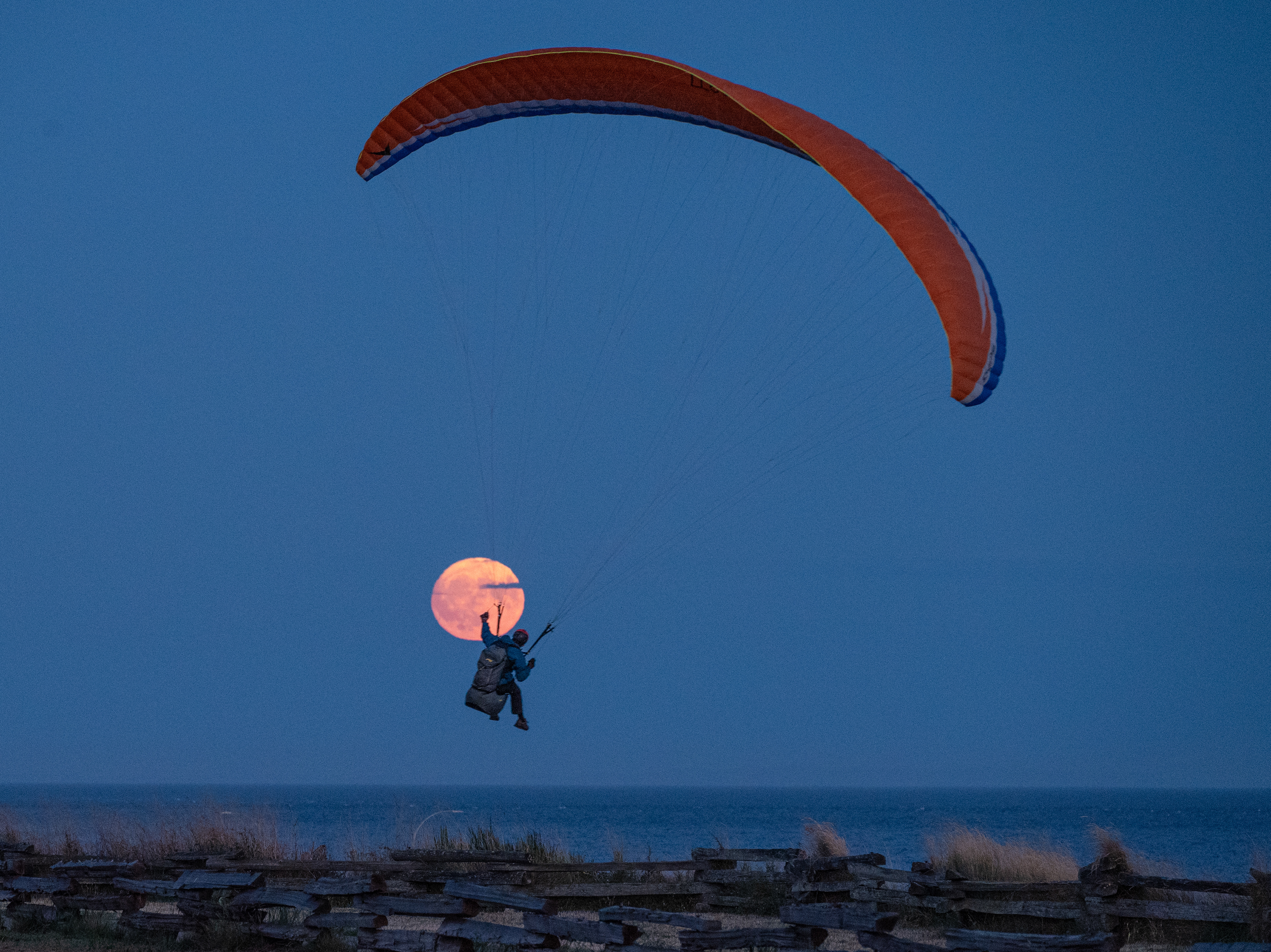 Moon with paraglider over Clover Point in Victoria.