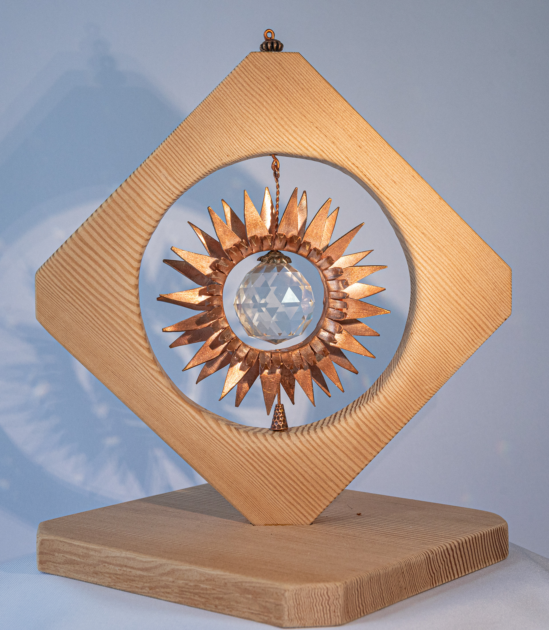 "Sunflower" is a copper flower with large crystal centre on a handmade fir base,  10.5 inches high x 7.5 inches wide x 7.5 inches deep, $175