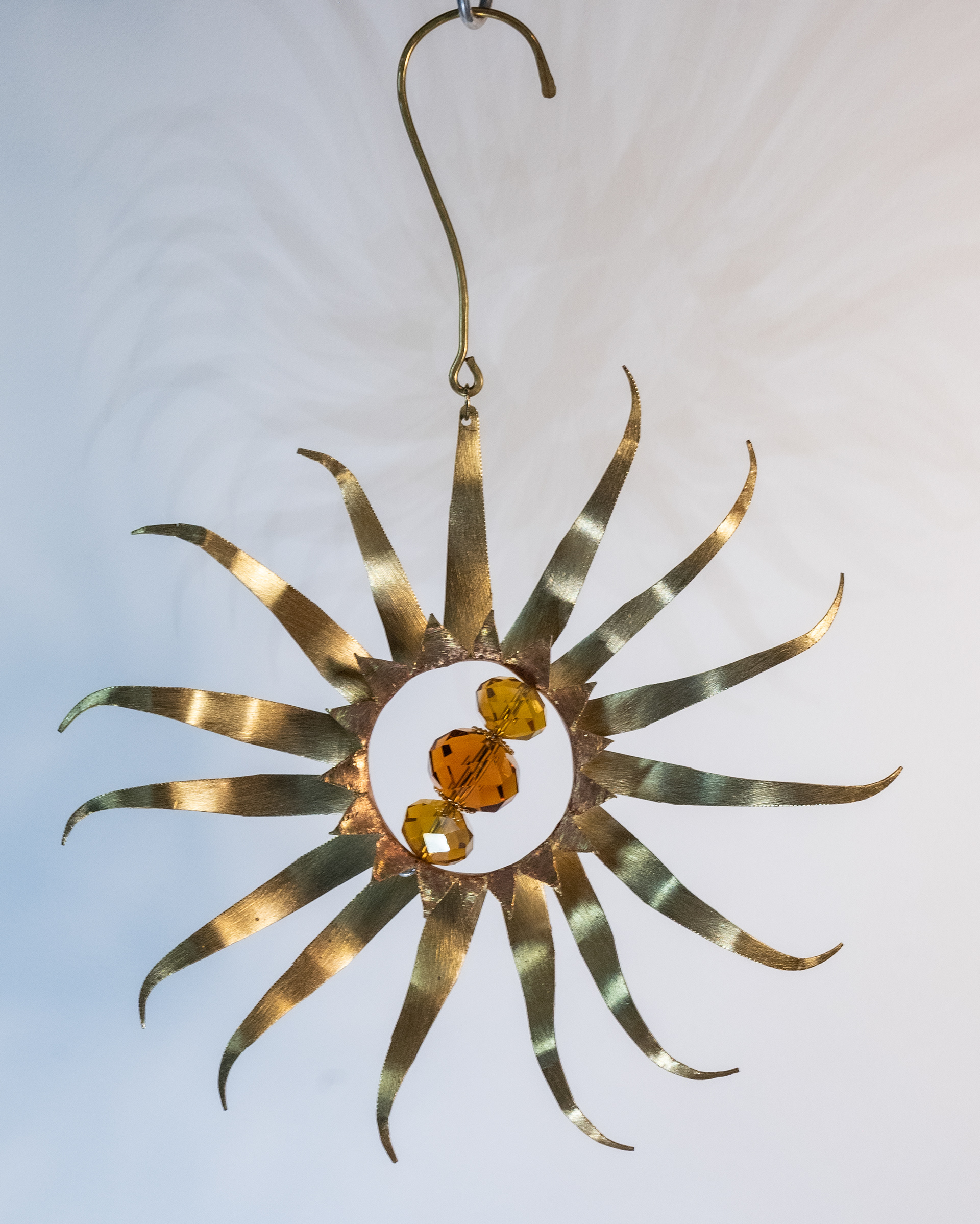 "Windmill" is handcut brass with amber glass crystals, $75