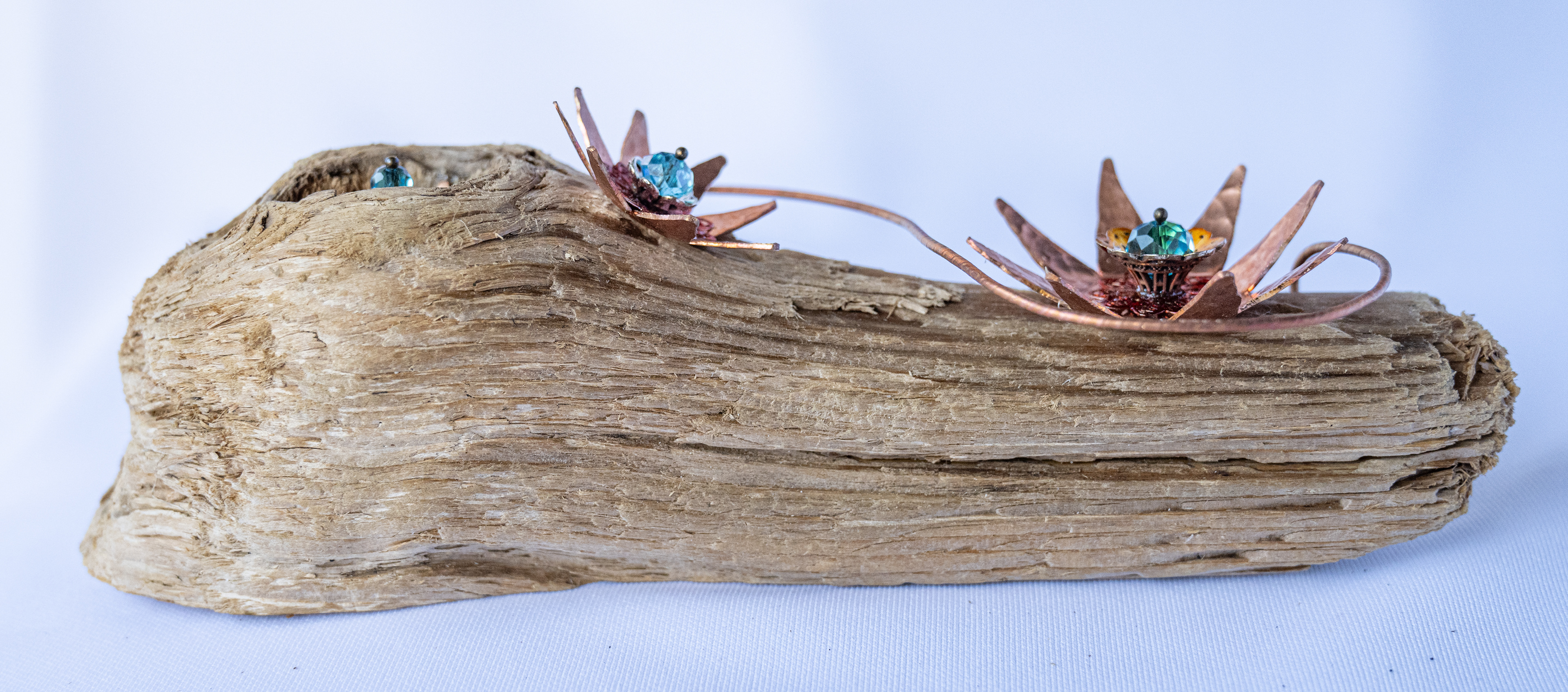 "Blue-ming' 6 x 2 x 2, has 3 copper flowers with crystal centres on Vancouver Island driftwood, $75