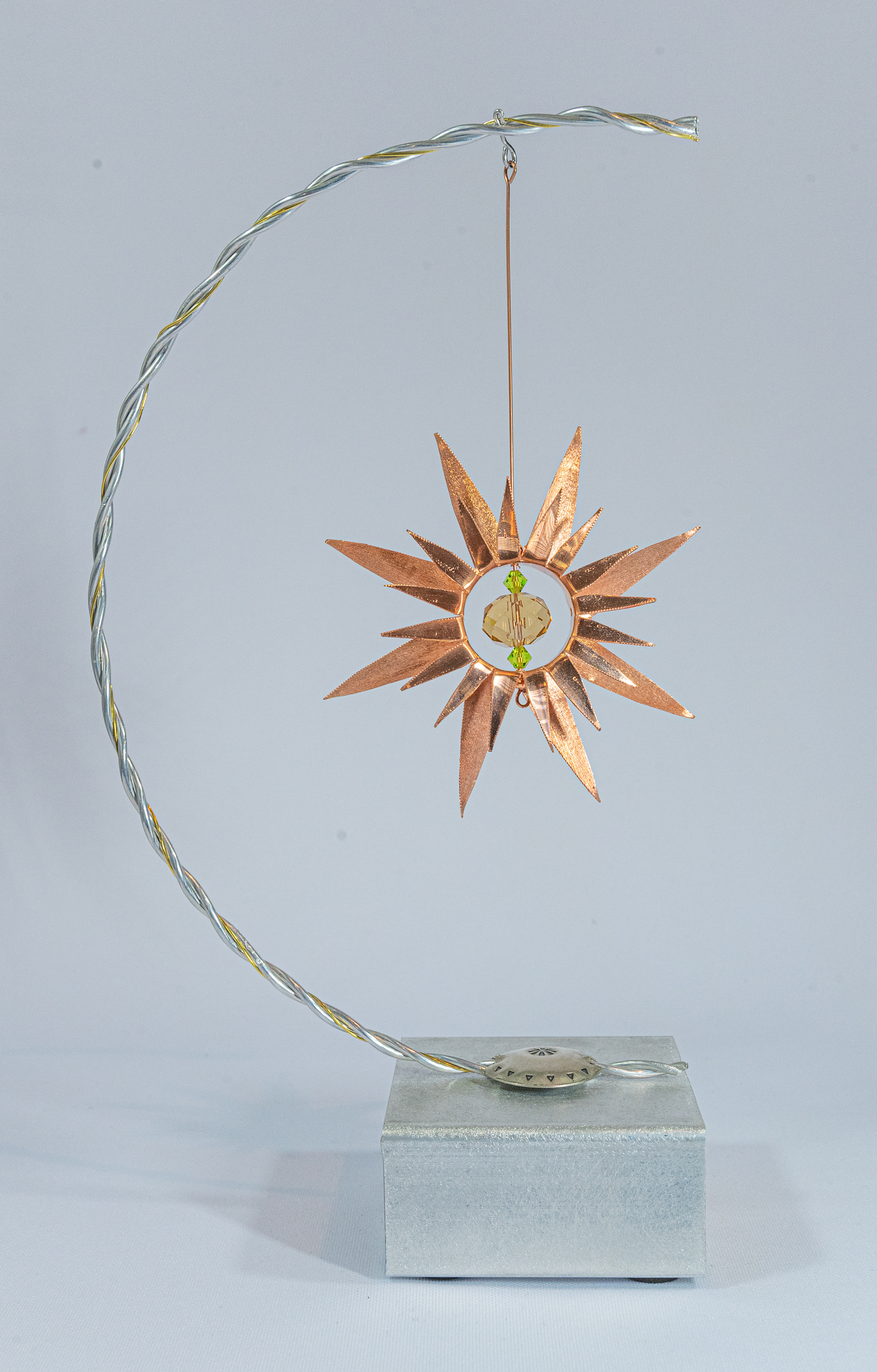 "Bloomed" features a twisted aluminum stem, copper flower and crystal centre on an aluminum base with cedar insert, 6 inches wide x 3 inches deep x 11 inches high, $125