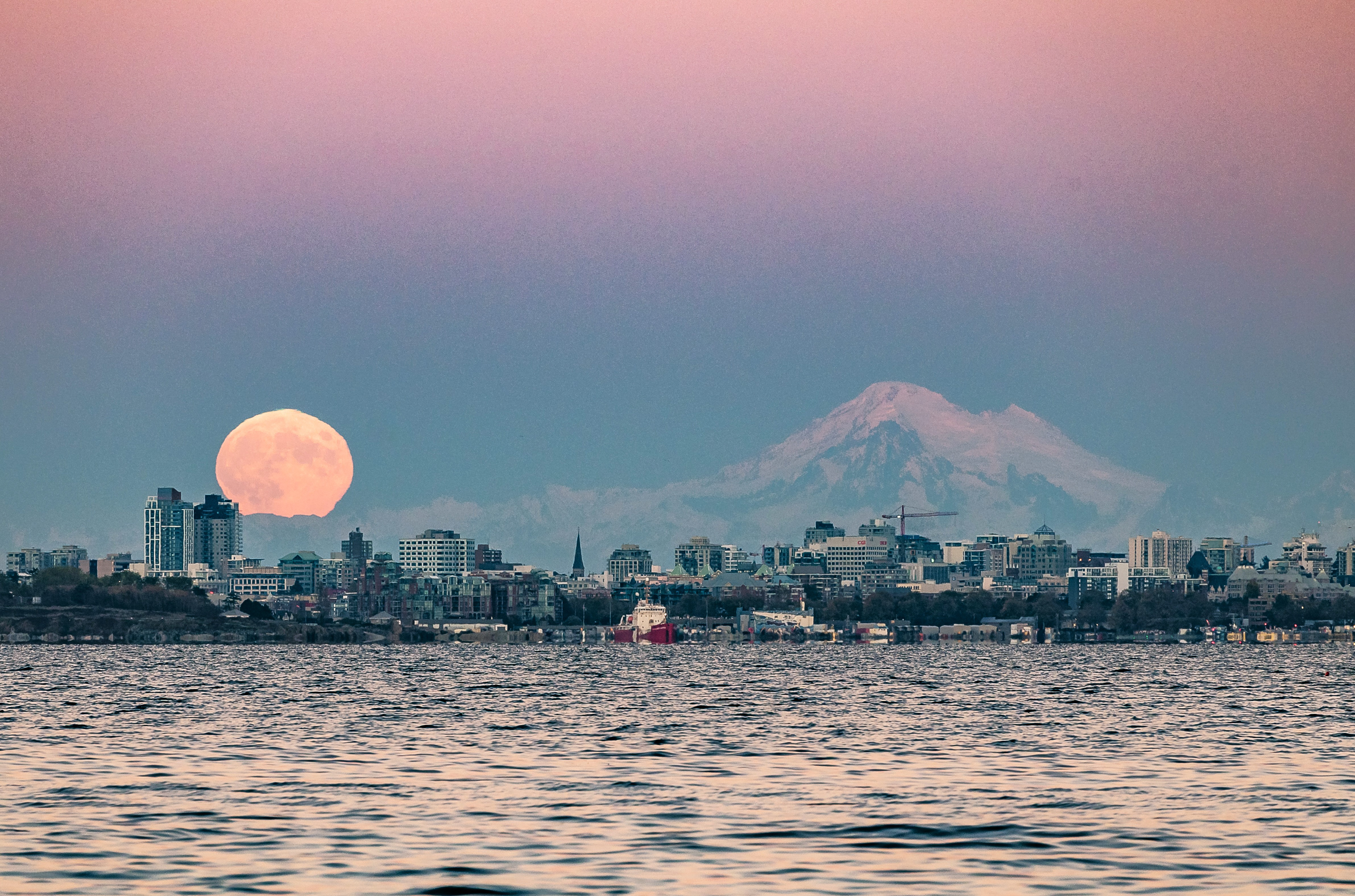 Moon rising over Victoria with Mount Baker.
