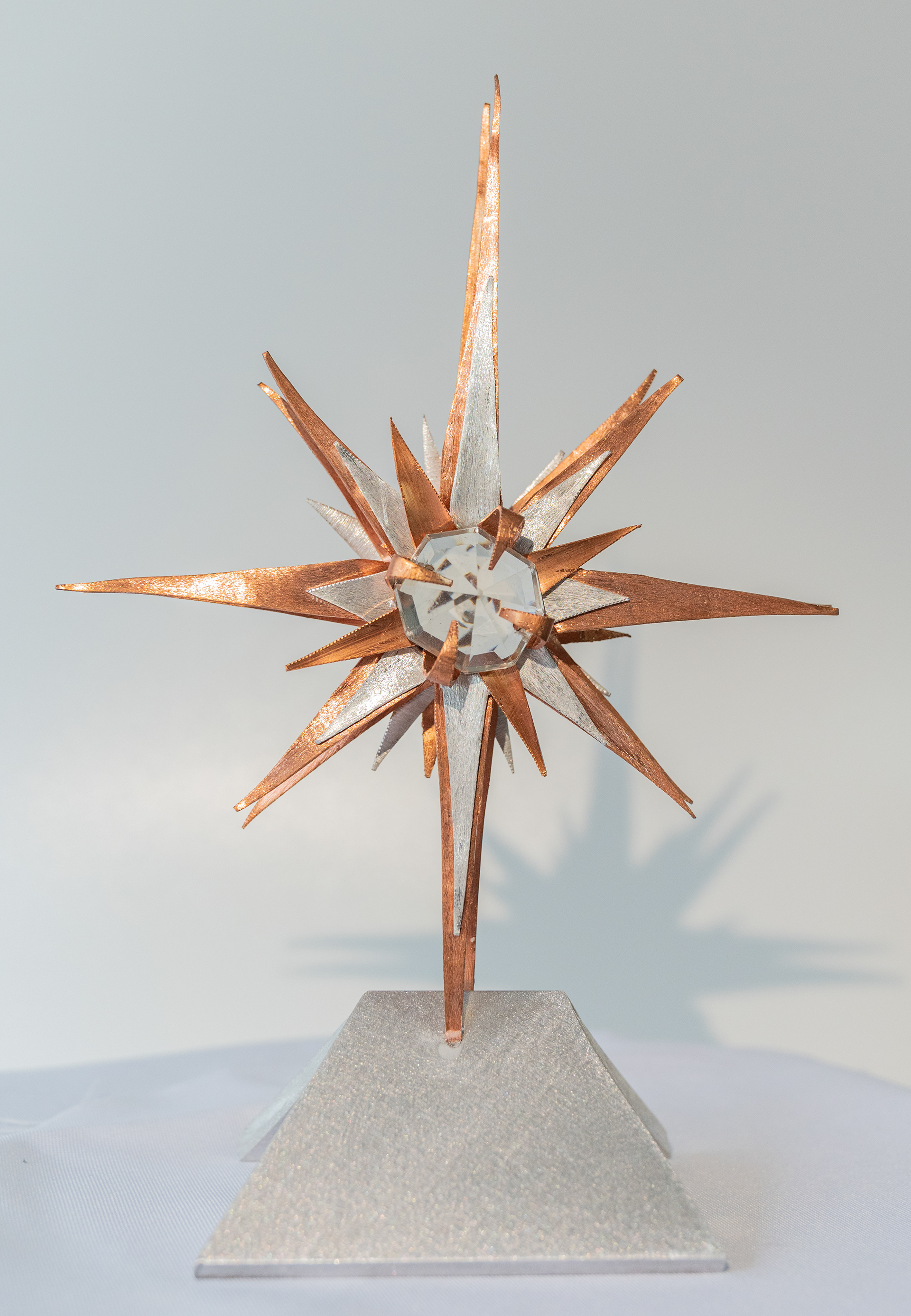 "Wish Upon a Star" is a copper and aluminum star with a clear crystal centre on an aluminum base. 5.5 inches wide x 8 inches high x 3 inches deep, $125