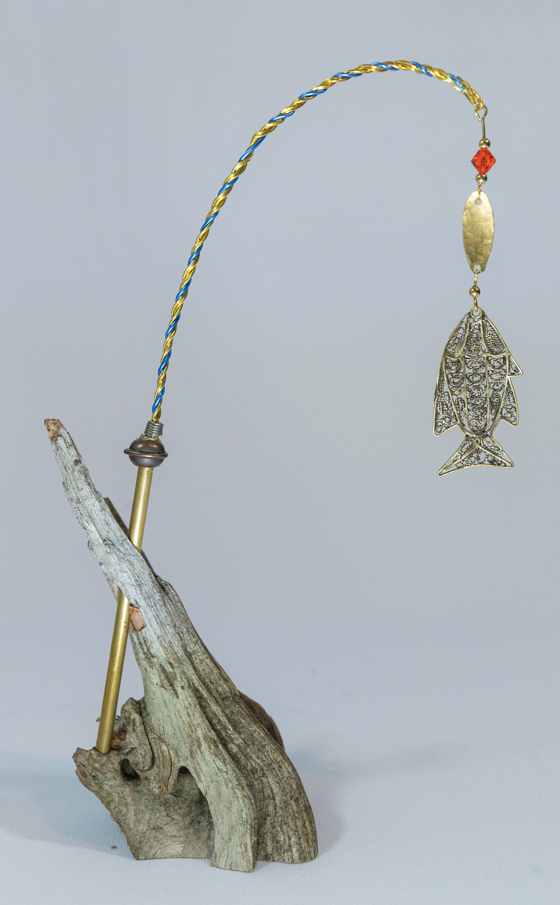 "Gone Fishing" is made with brass and twisted wire with upcycled brass findings with a glass crystal on a driftwood base, 5 inches wide, 3 inches deep x 8 inches high, $55