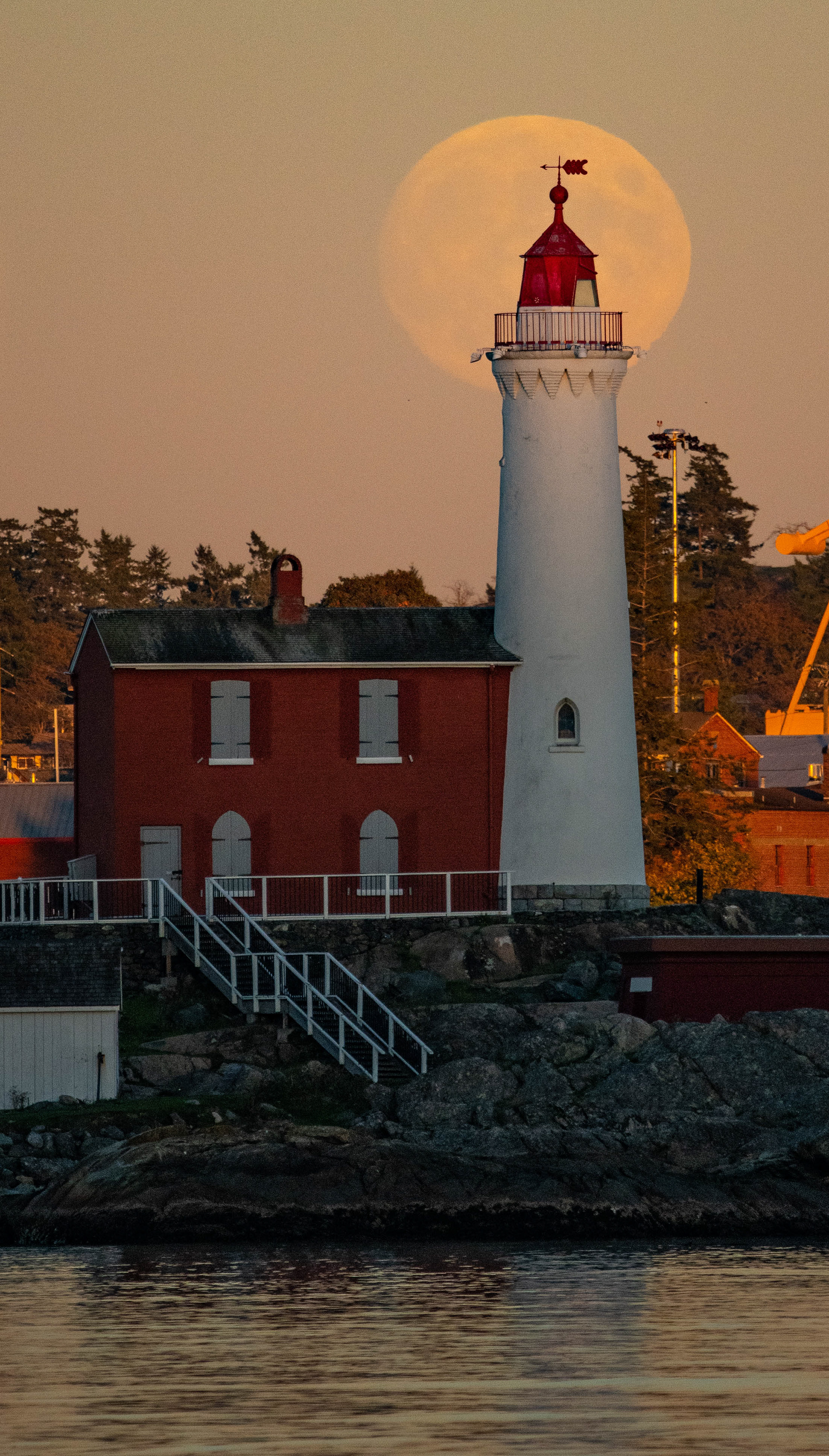 Full moon behind the Fisgard Lighthouse in Victoria.