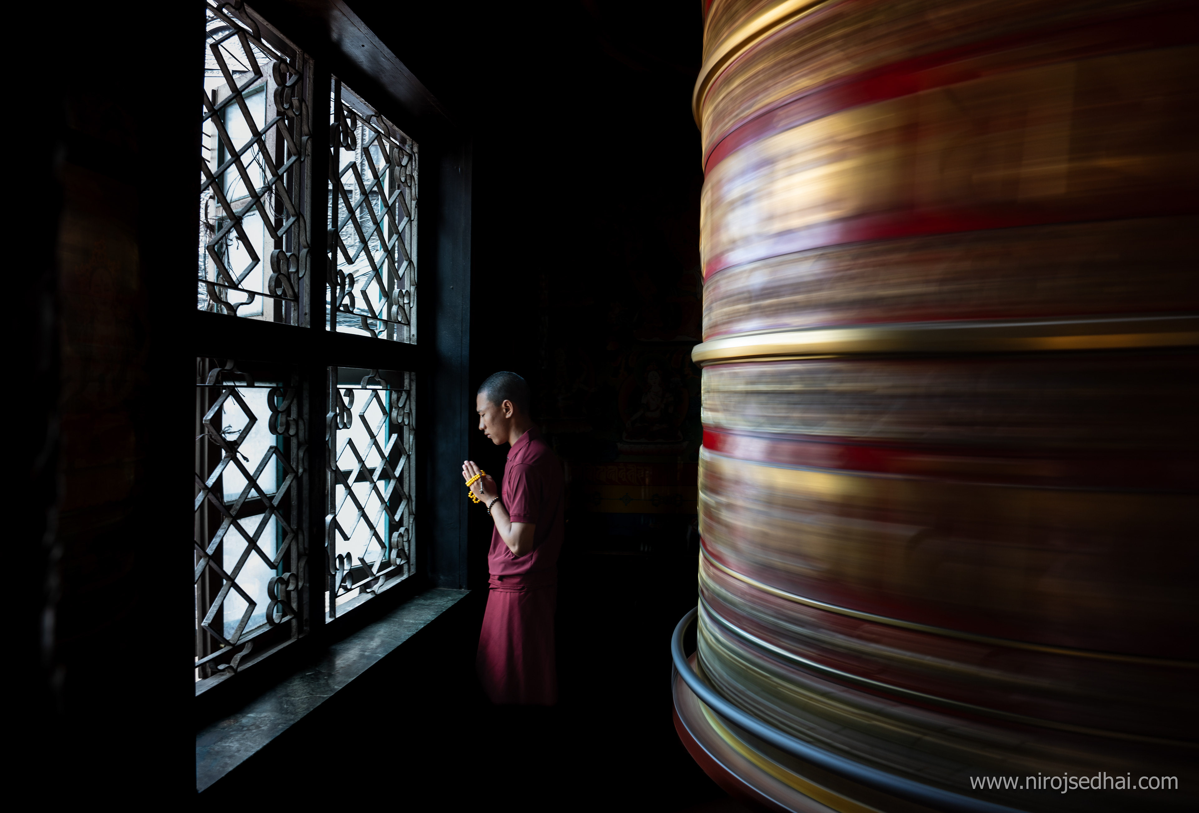 Young monk praying in Bouddhanath stupa