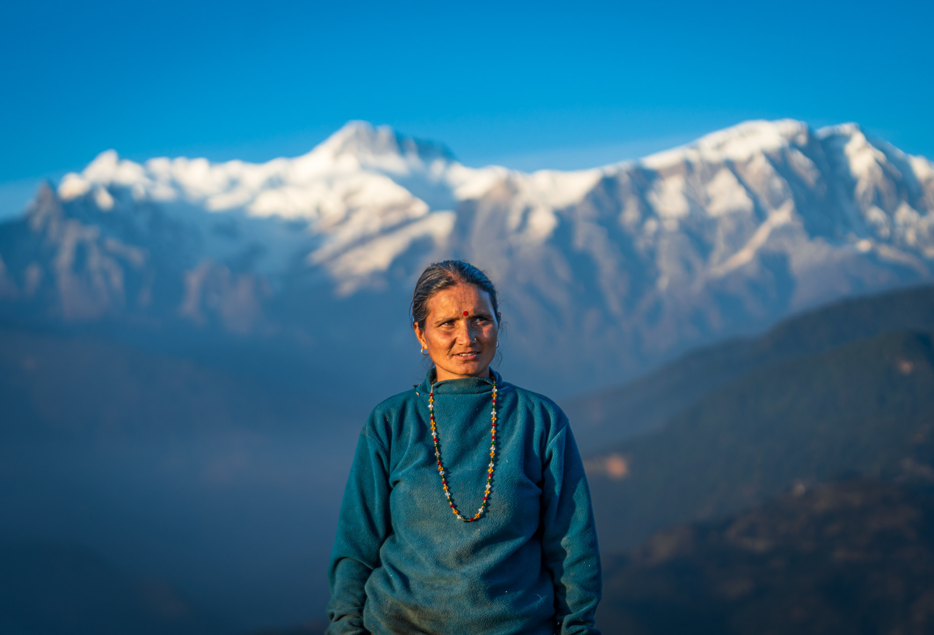 Farmer in Kaski annapurna range in background